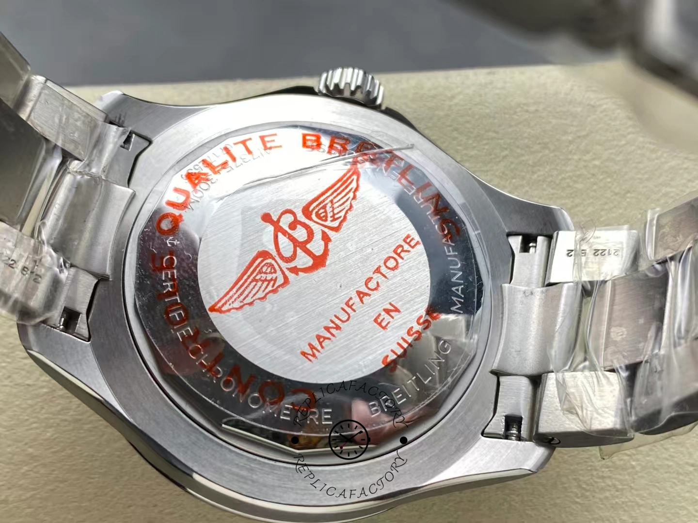Caseback of Breitling Superocean 42 A17375E71C1A1 with red winged logo engraving.