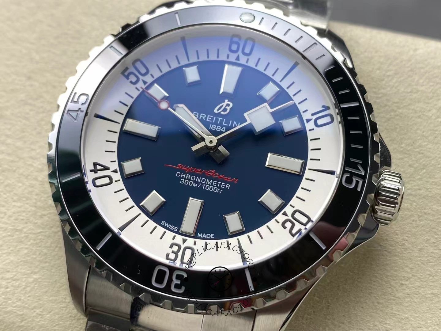 Close-up of Breitling Superocean 44 A17376211C1A1 blue dial showing luminous hour markers.