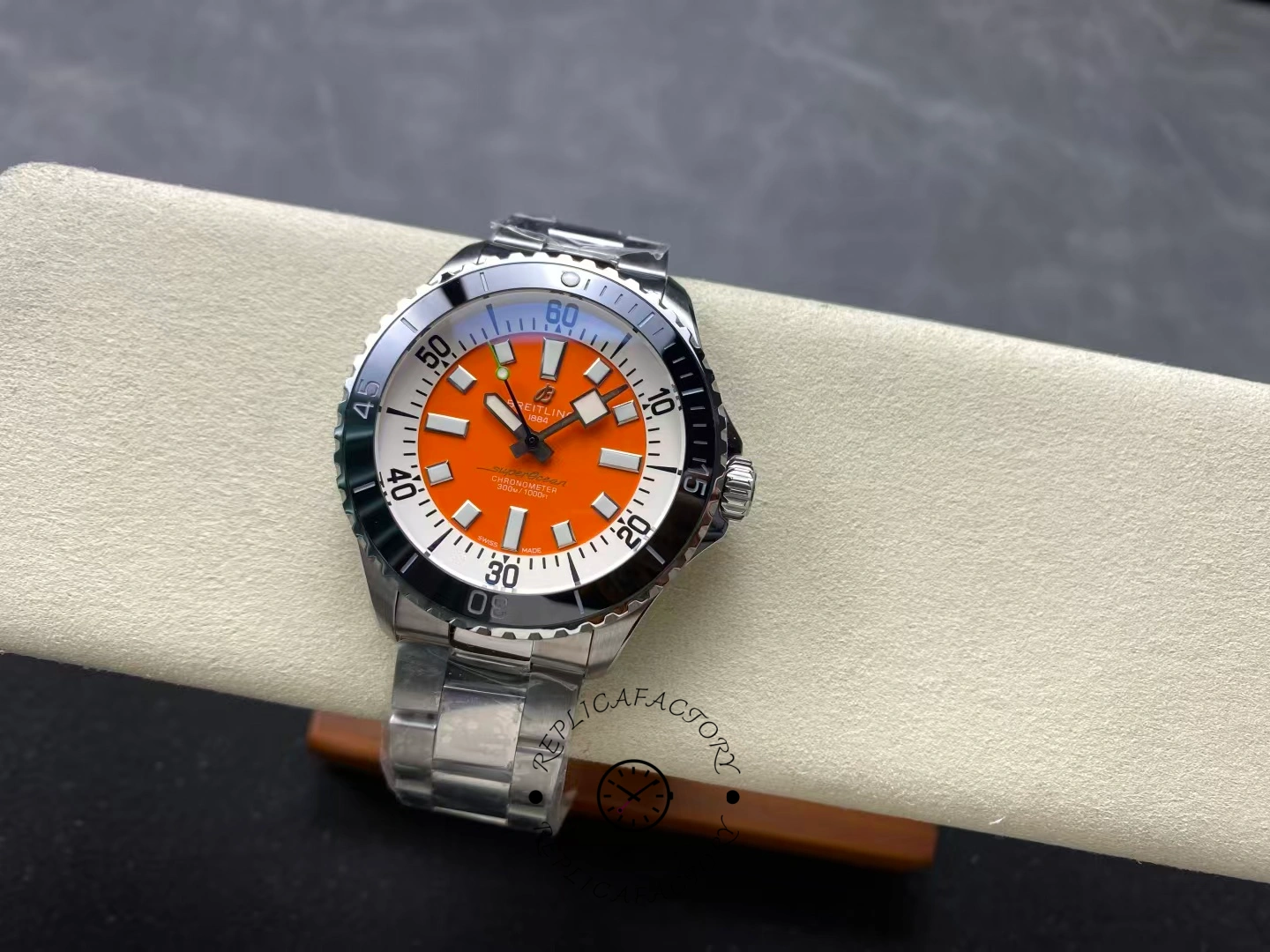 Angled view of Breitling Superocean 42 A173751A1O1S1 orange dial with black bezel.