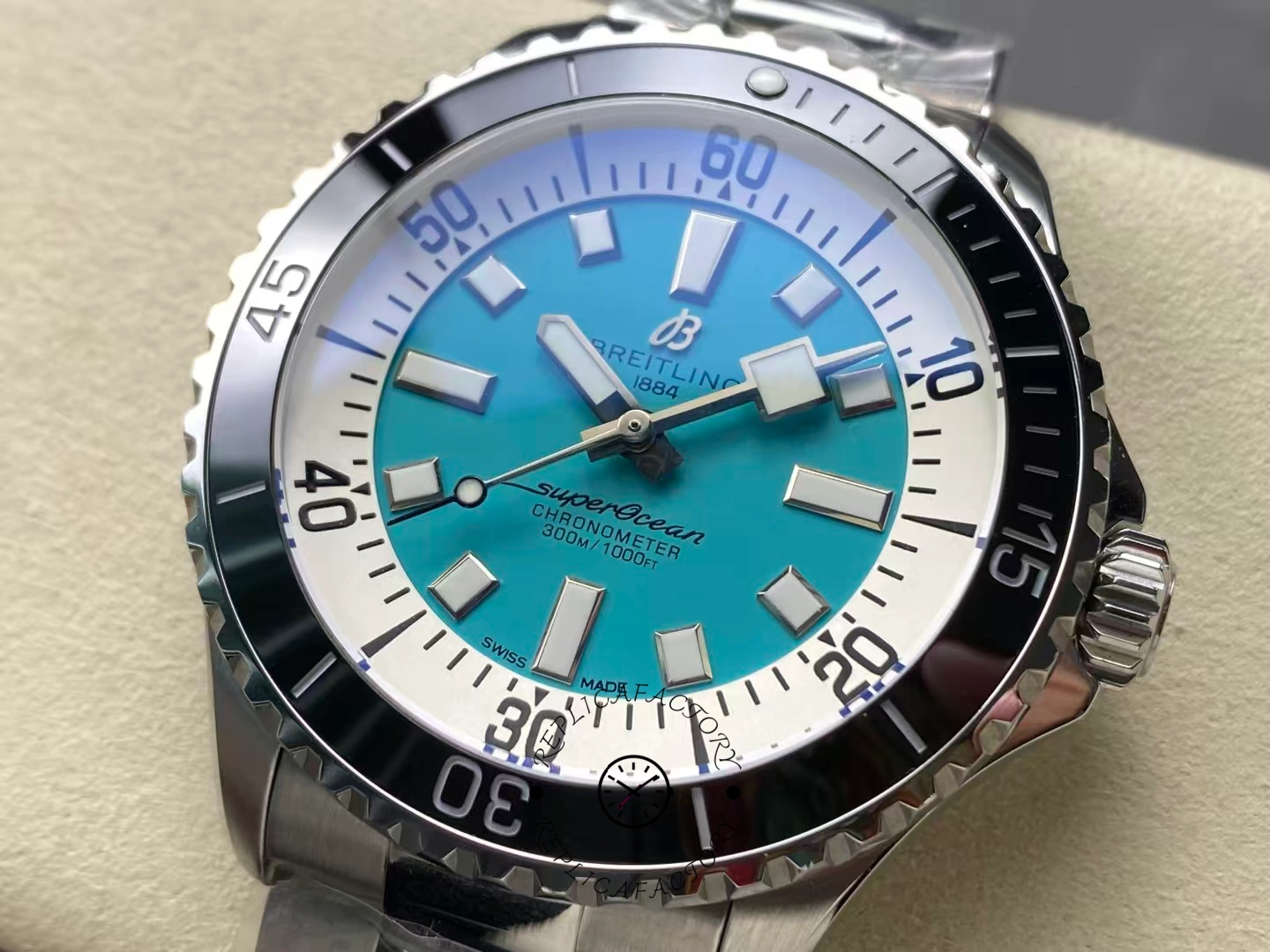 Close-up of Breitling Superocean 44 A17376211L2A1 turquoise dial with black bezel.