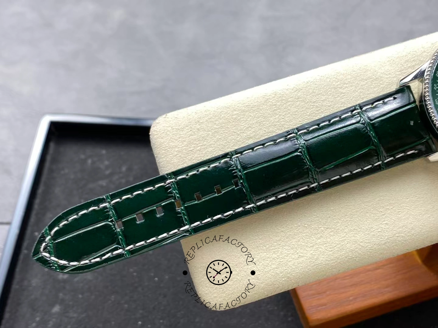 Green leather strap of Breitling Navitimer 41 A17326361L1P1 showing stitching details.