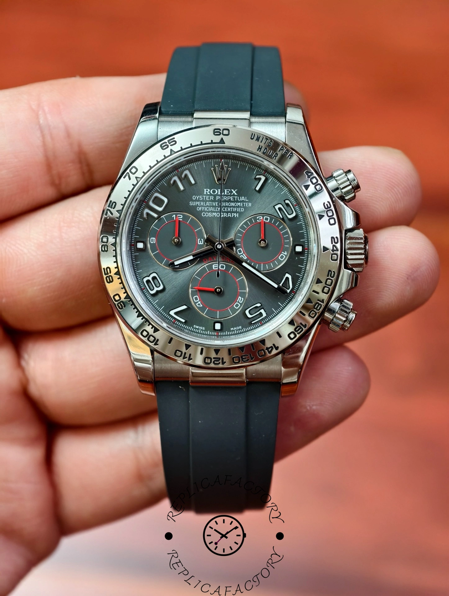 Handheld view of the Rolex Daytona 116519 highlighting the grey dial, Arabic numerals, and polished tachymeter bezel.