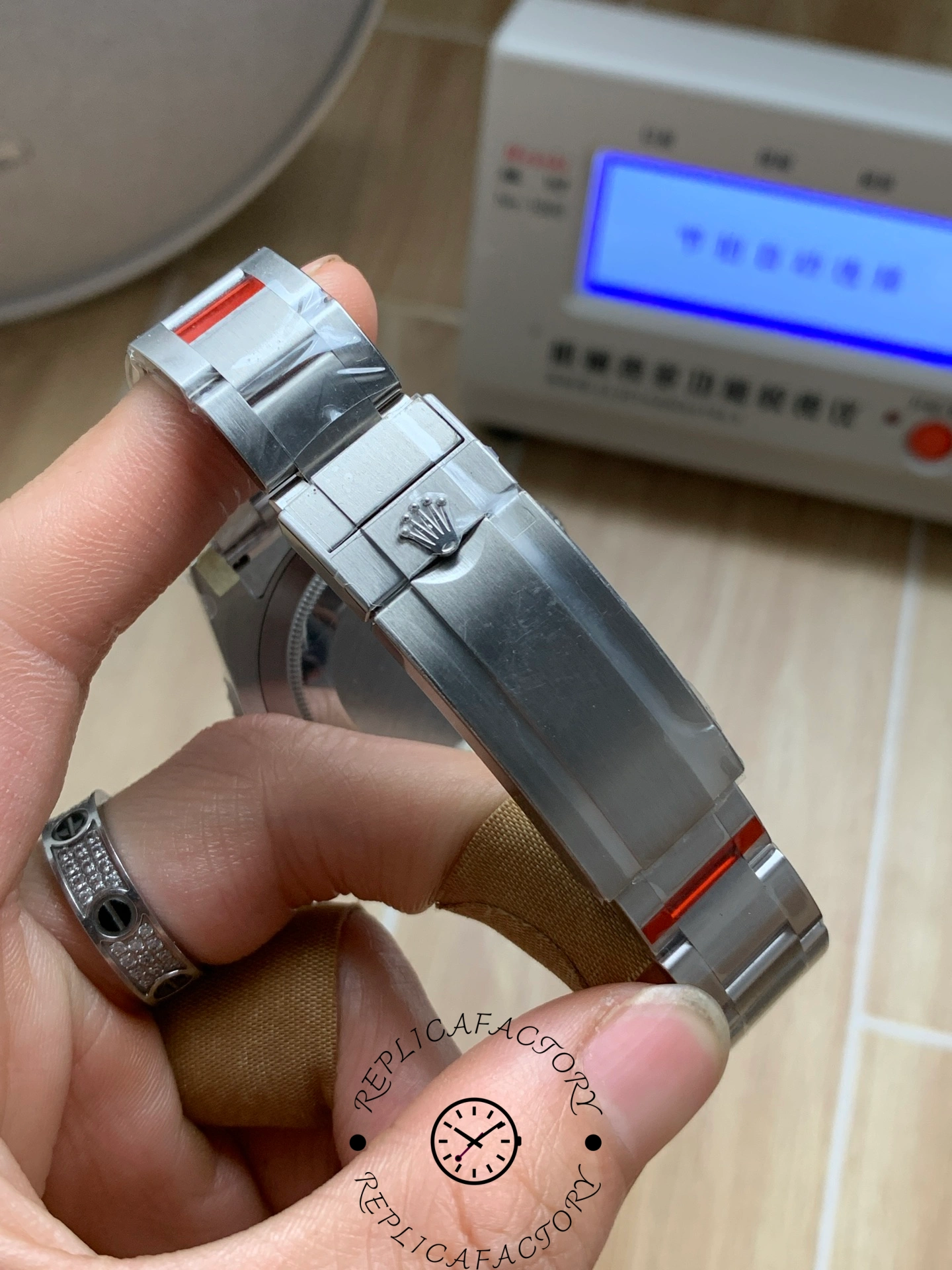 View of Rolex Submariner 126619LB clasp exterior with engraved crown logo.