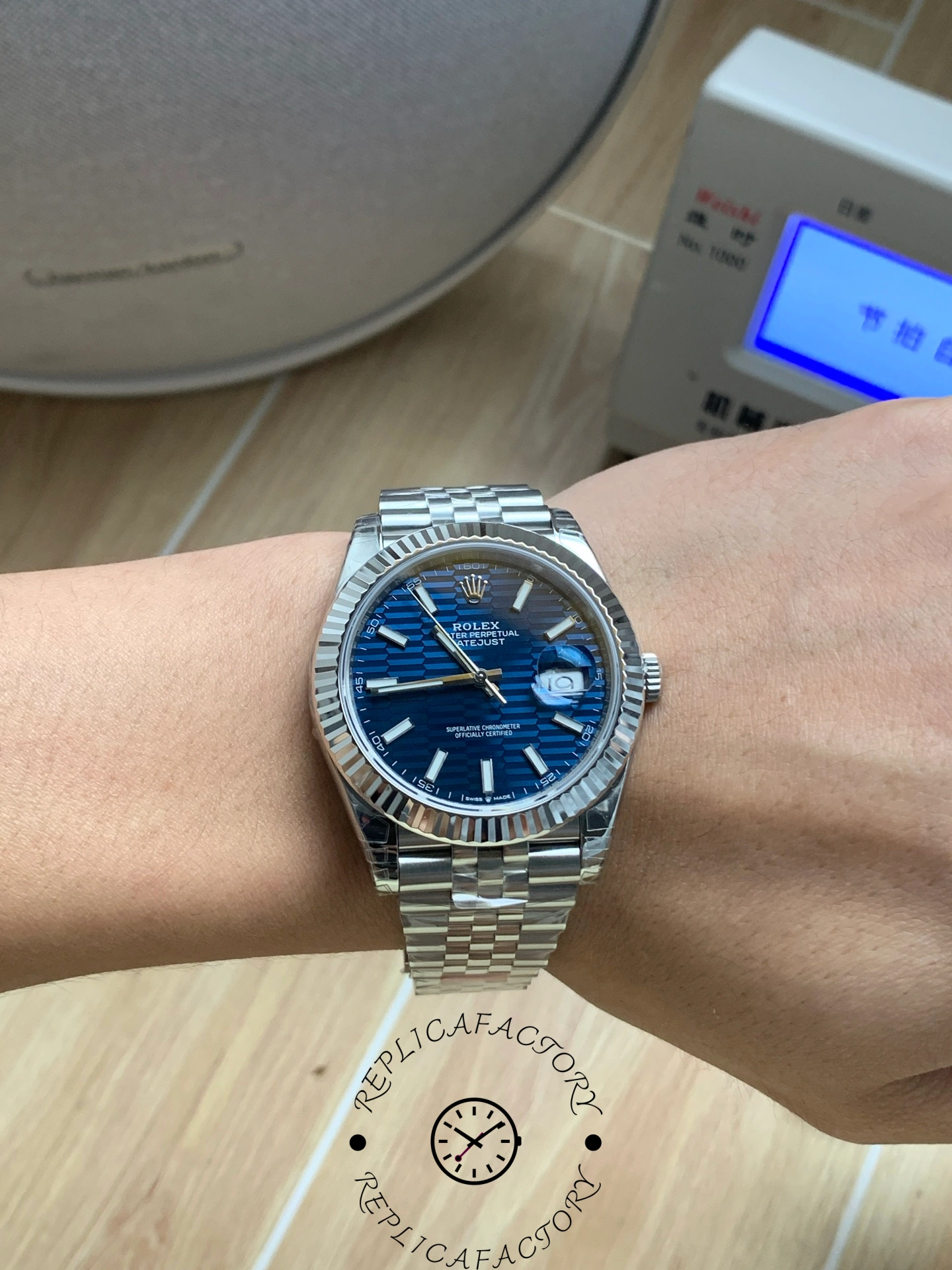 Wrist shot of Rolex Datejust 126334 with blue textured dial and Jubilee bracelet.
