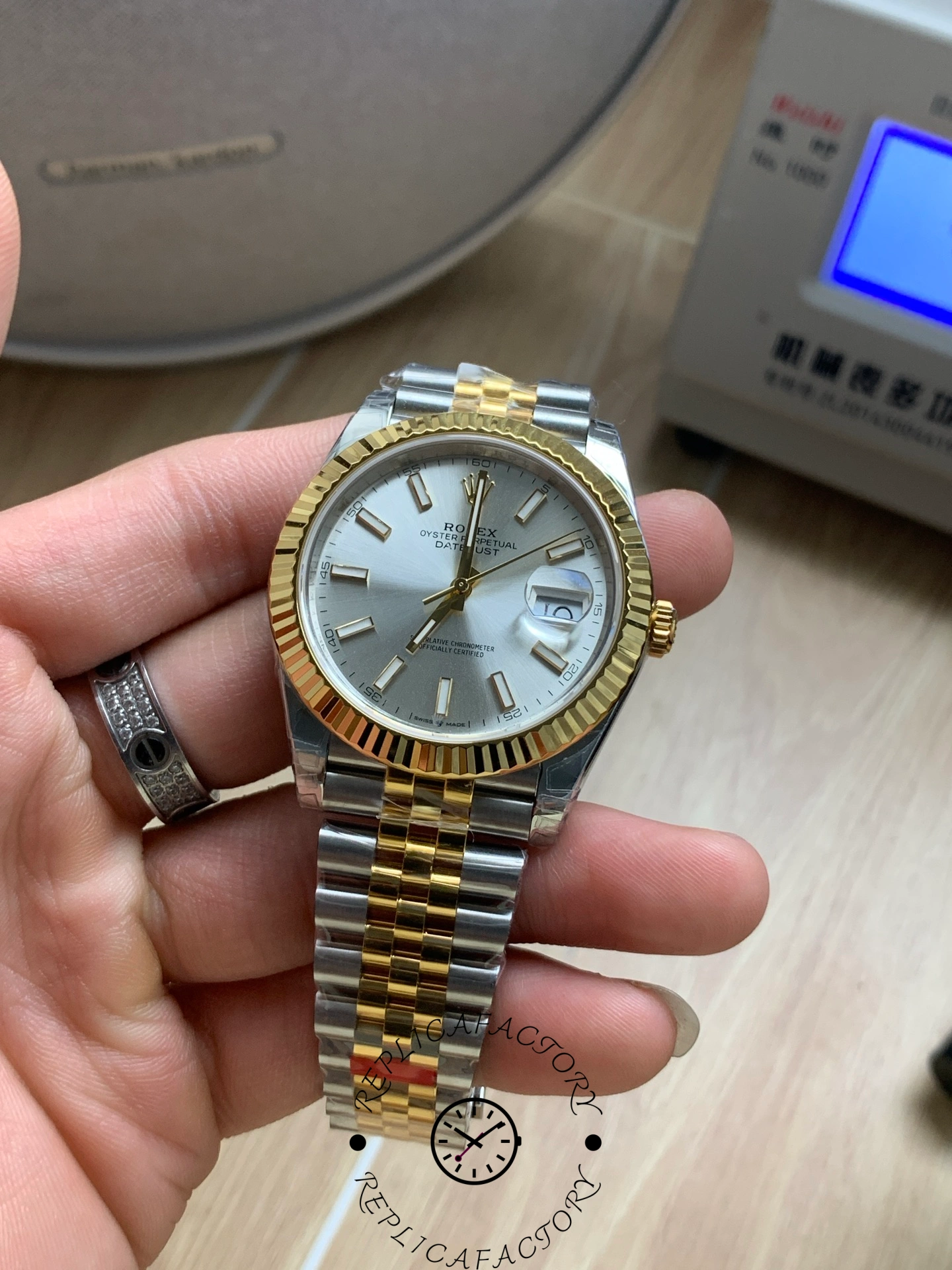 Close handheld shot of the Rolex Datejust 41 M126333-0002 with gold fluted bezel.