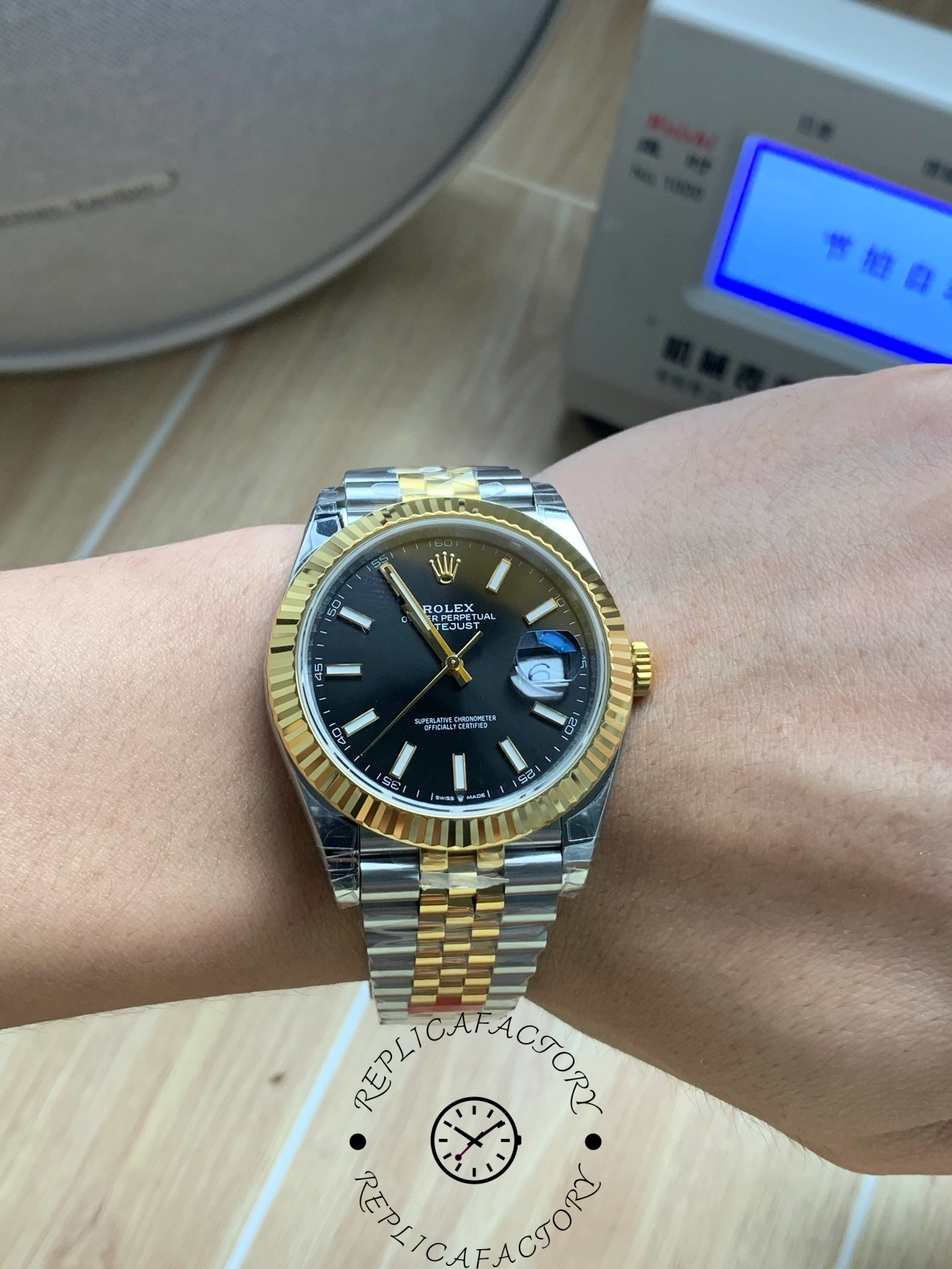Wrist shot of Rolex Datejust 41 126333 showing black dial and two-tone bracelet.