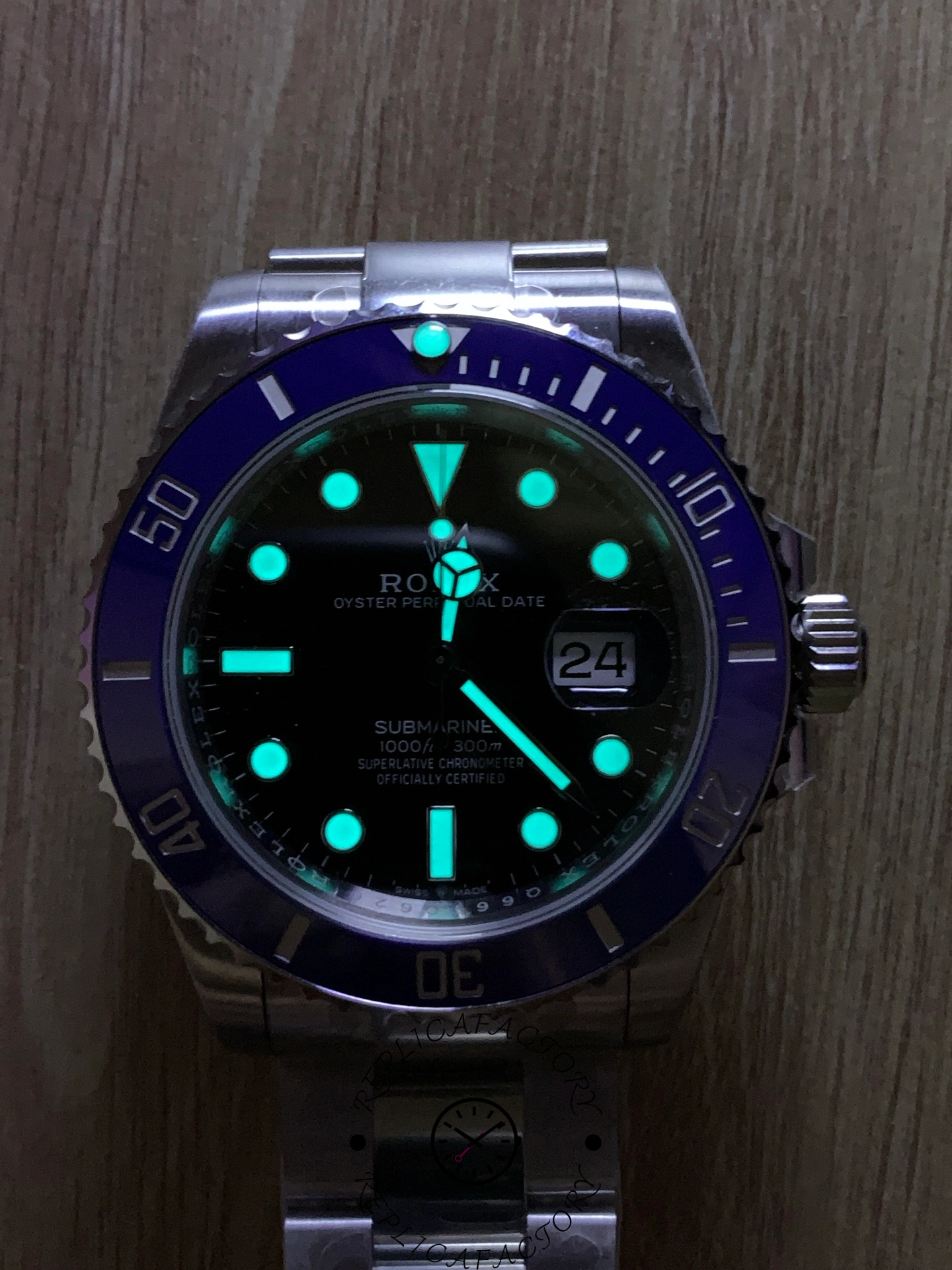 Lume view of Rolex Submariner 126619LB showing glowing hour markers and hands.