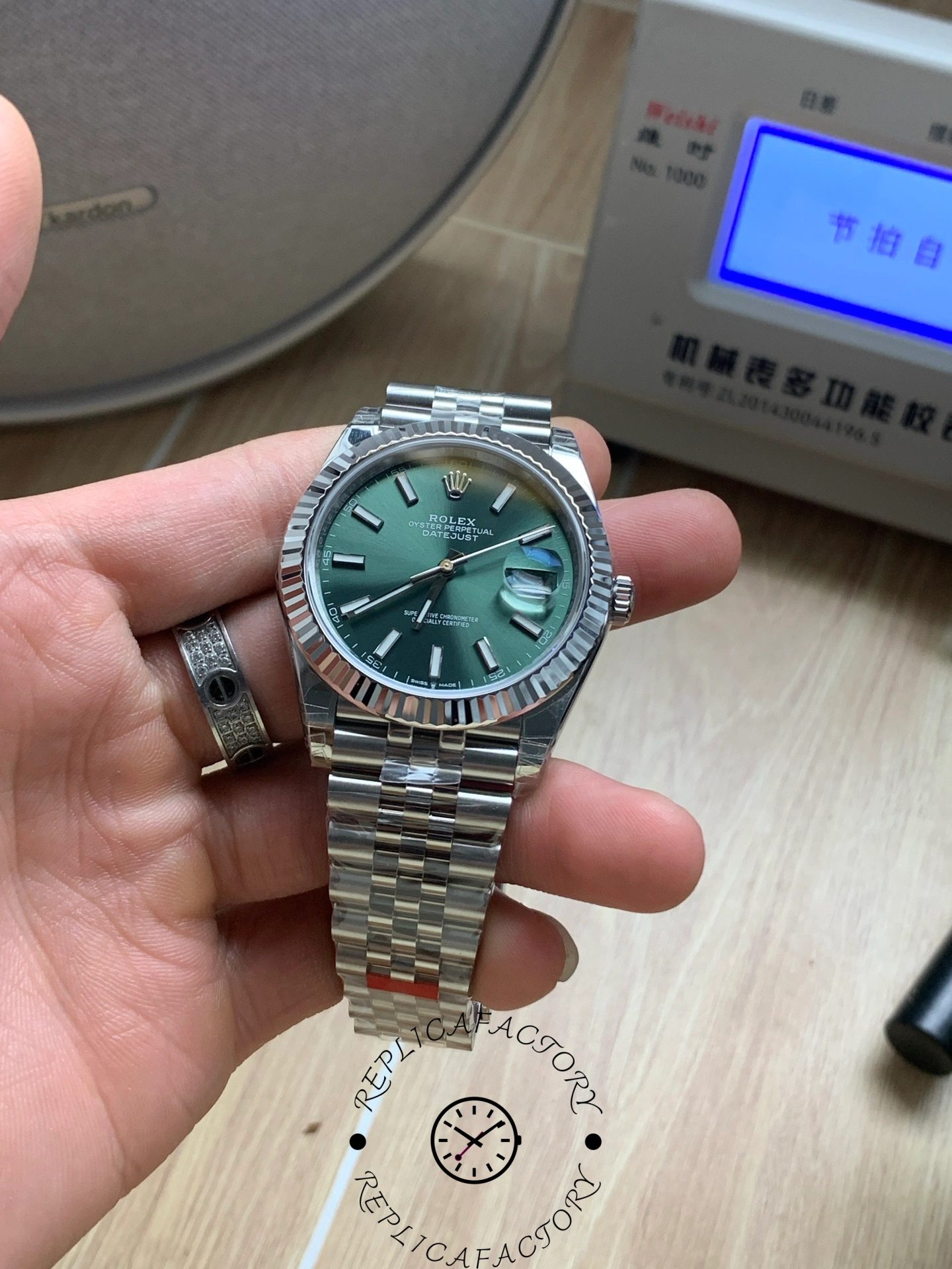 Angled hand-held shot of Rolex Datejust 126334 VS with green dial.