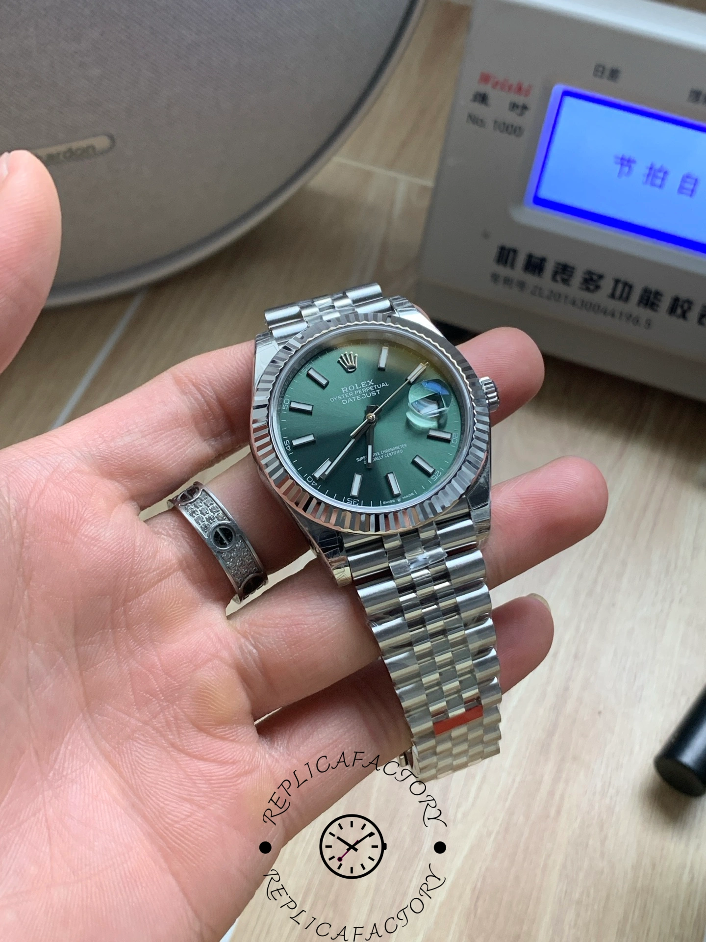 Close-up of Rolex Datejust 126334 VS showing green dial and date window.