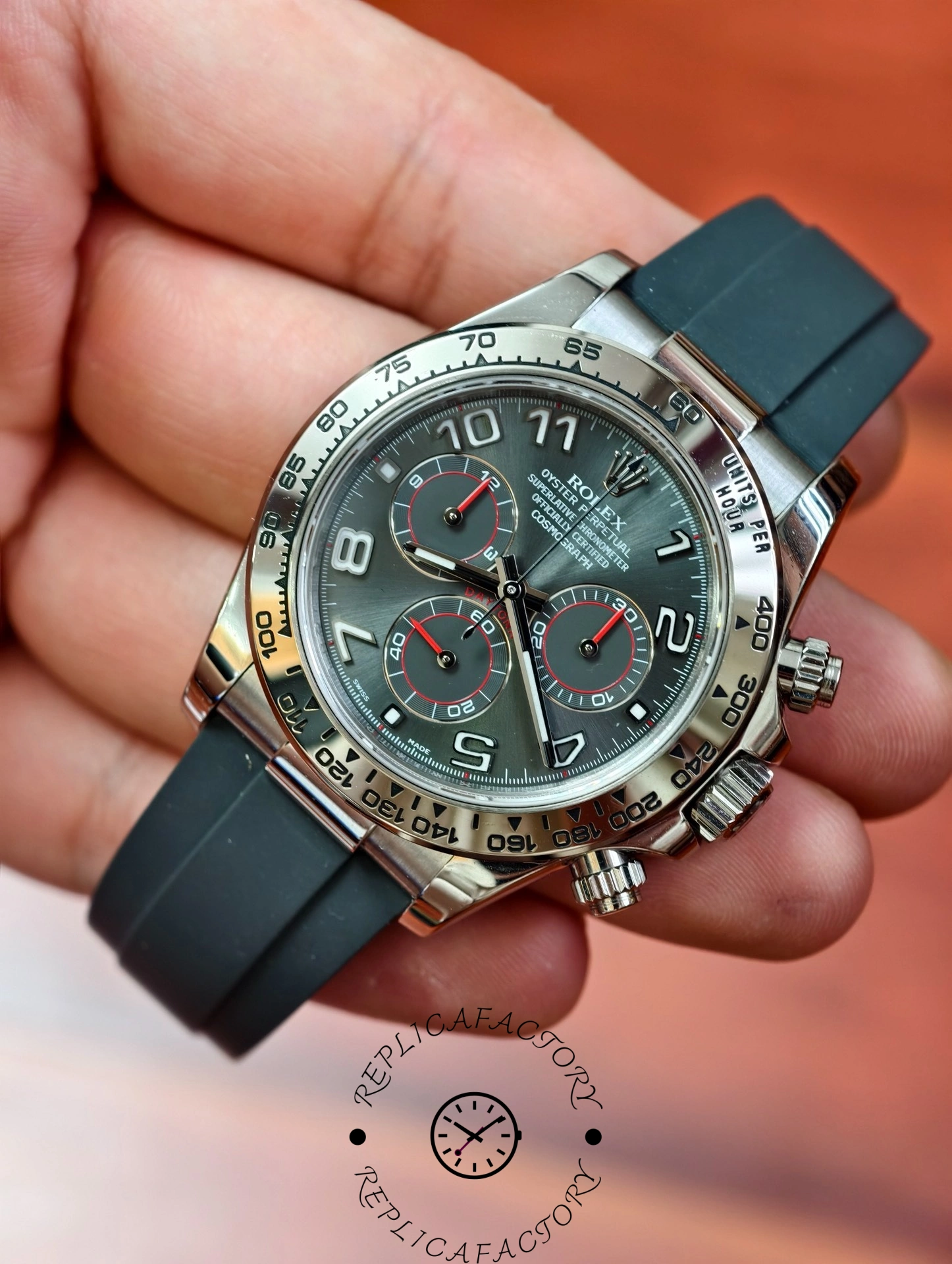 Close-up handheld shot of the Rolex Daytona 116519 featuring red-trimmed chronograph subdials and Oysterflex strap.