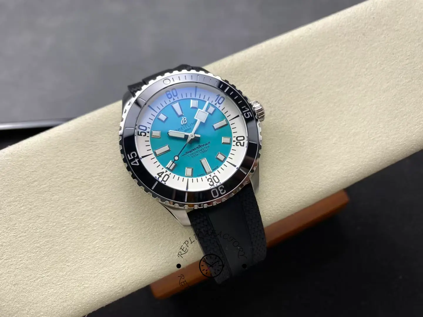 Angled view of Breitling Superocean 44 A17376211L2S1 turquoise dial with black ceramic bezel.