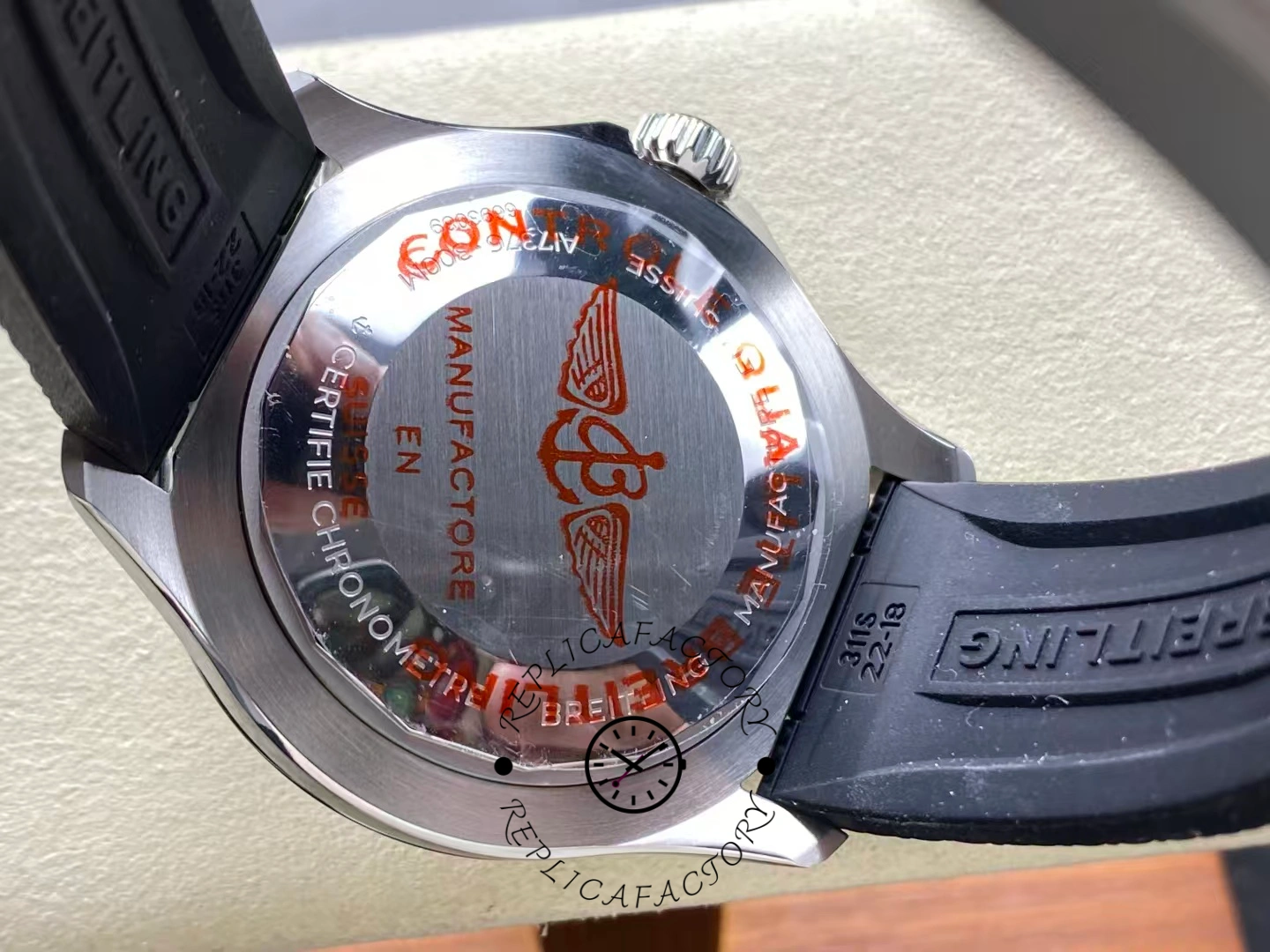 Caseback of Breitling Superocean 44 A17376211B1S1 with red Breitling wing logo.