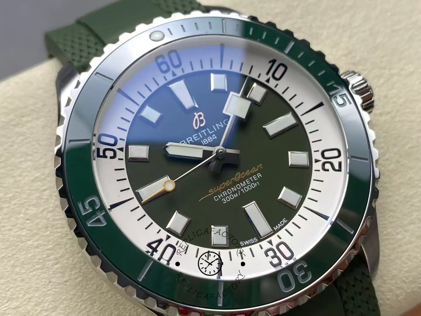 Macro shot of Breitling Superocean A17376A31L1S1 green ceramic bezel and steel crown.