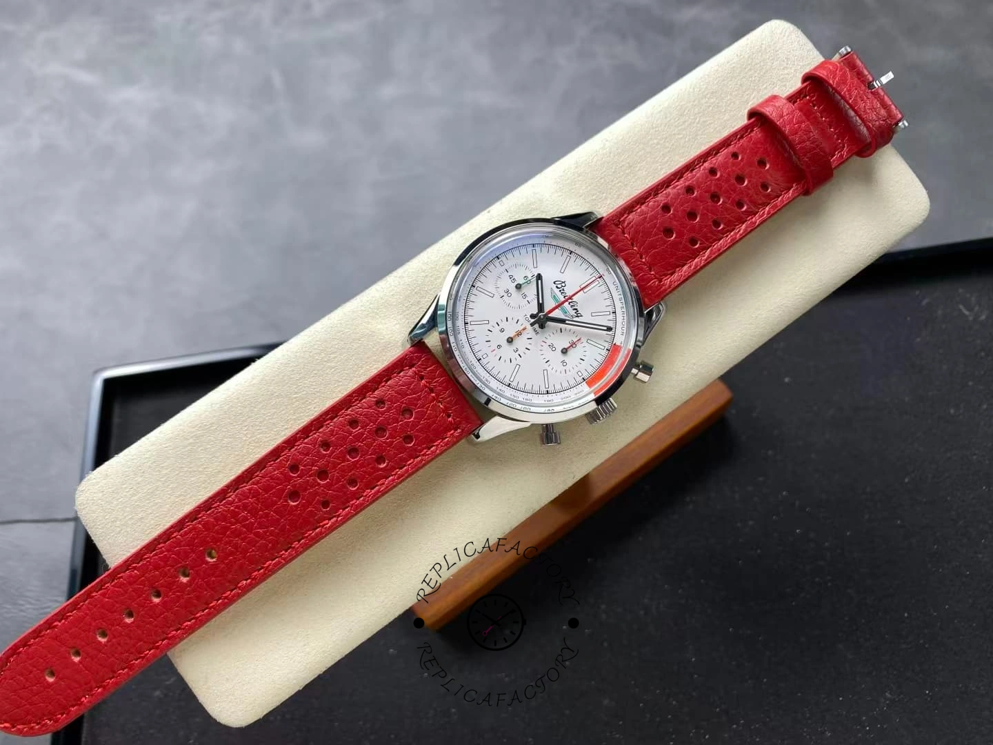 Full view of Breitling Top Time B01 AB01766A1A1X1 white dial on red strap.