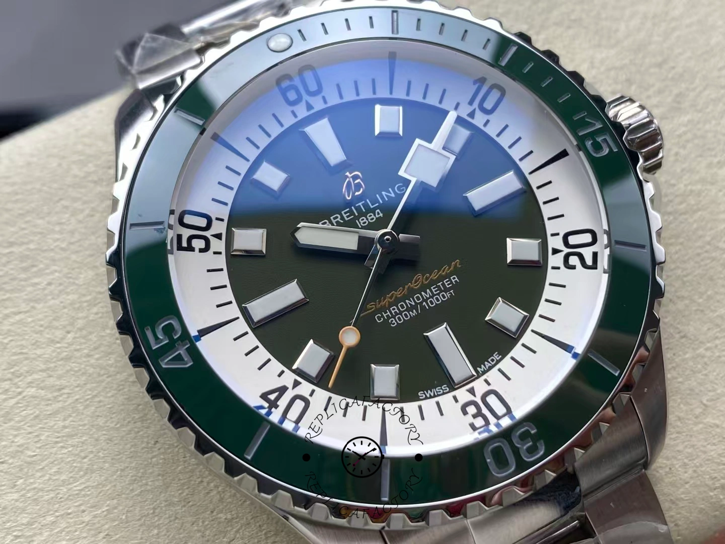 Macro view of Breitling Superocean 44 A17376A31L1A1 green dial showing luminous markers.