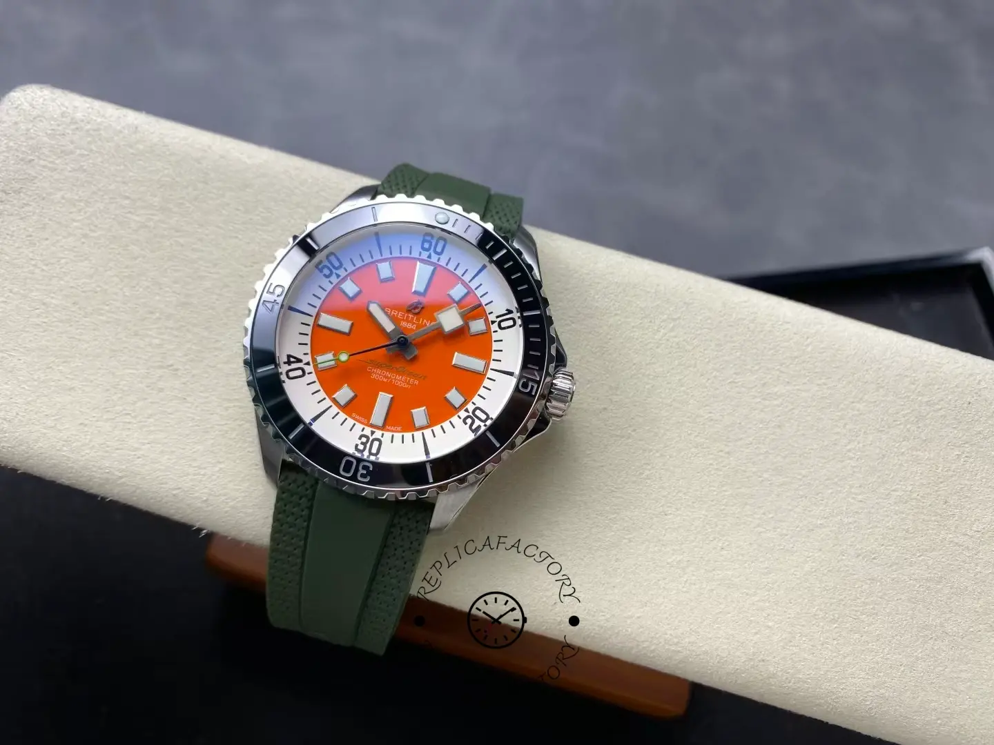 Angled top view of Breitling Superocean A173751A1O1S1 with orange dial and black bezel.