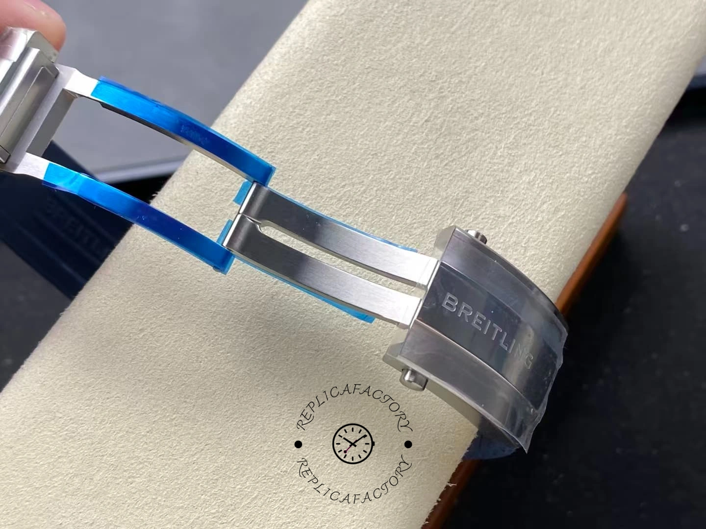 Folding clasp of Breitling Superocean A17375E71C1S1 showing blue film and steel buckle.