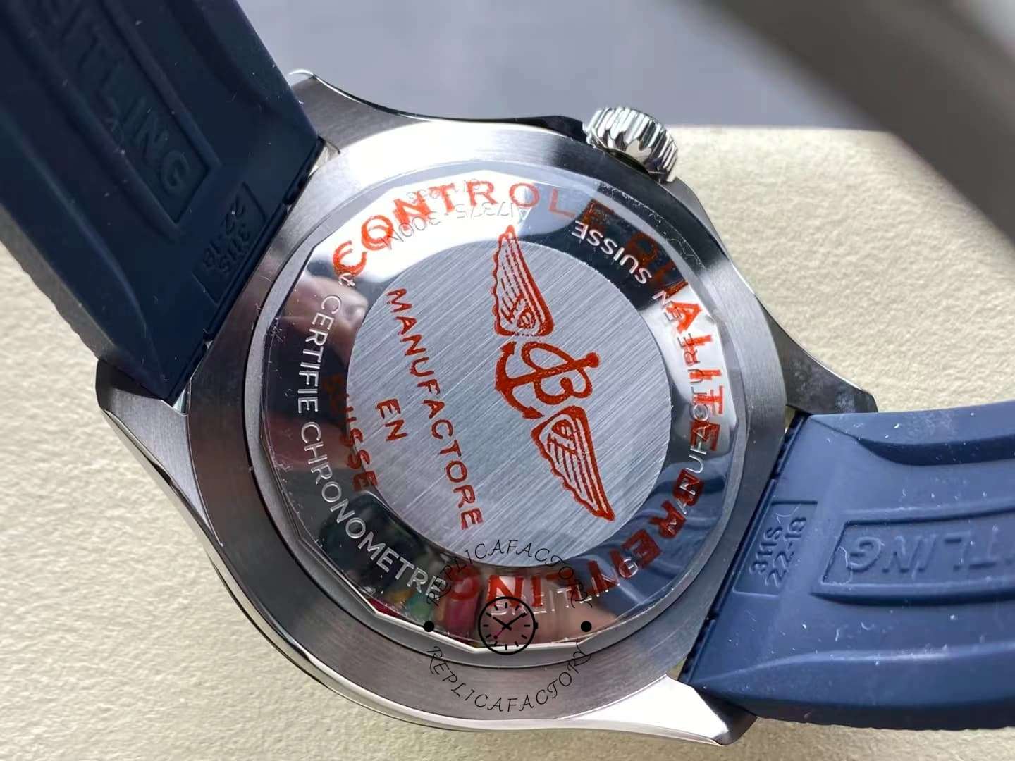 Caseback of Breitling Superocean A17376211C1S1 with red winged B logo engraving.