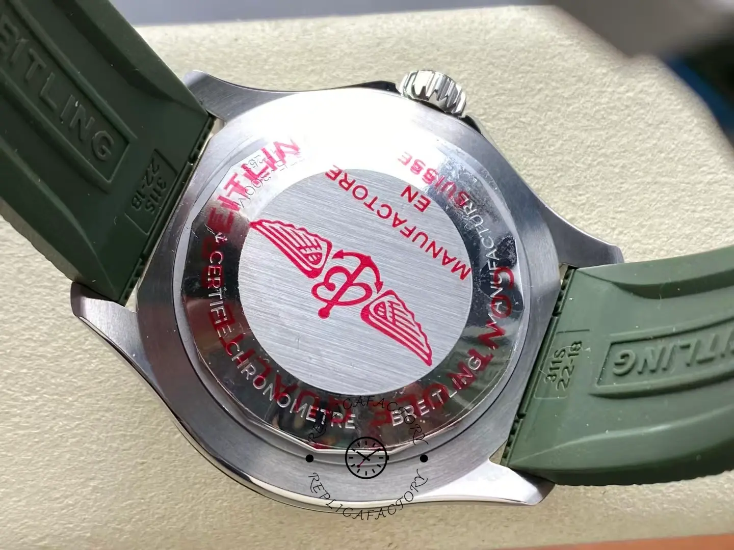 Caseback of Breitling Superocean A173751A1O1S1 Kelly Slater Edition showing red logo.