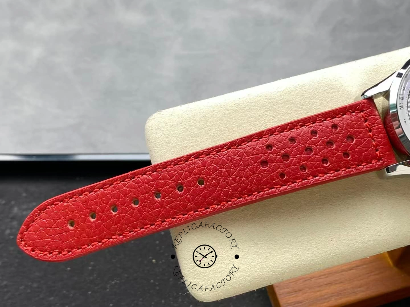 Close view of Breitling Top Time B01 AB01766A1A1X1 perforated red leather strap.