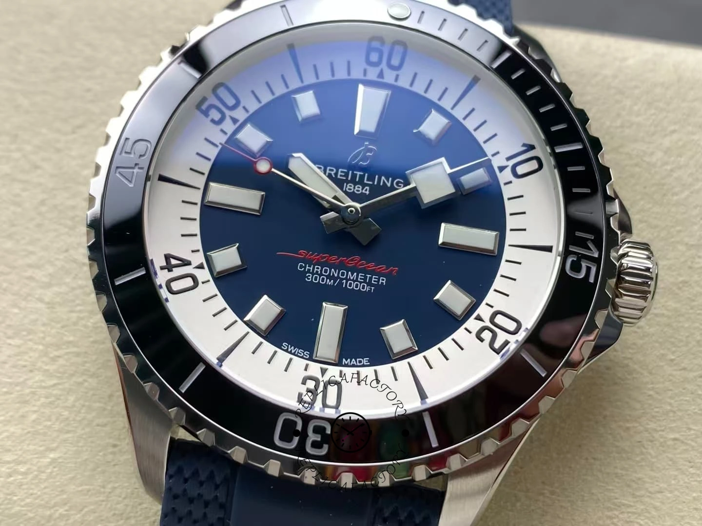 Close-up of Breitling Superocean A17376211C1S1 blue dial with black bezel and white ring.