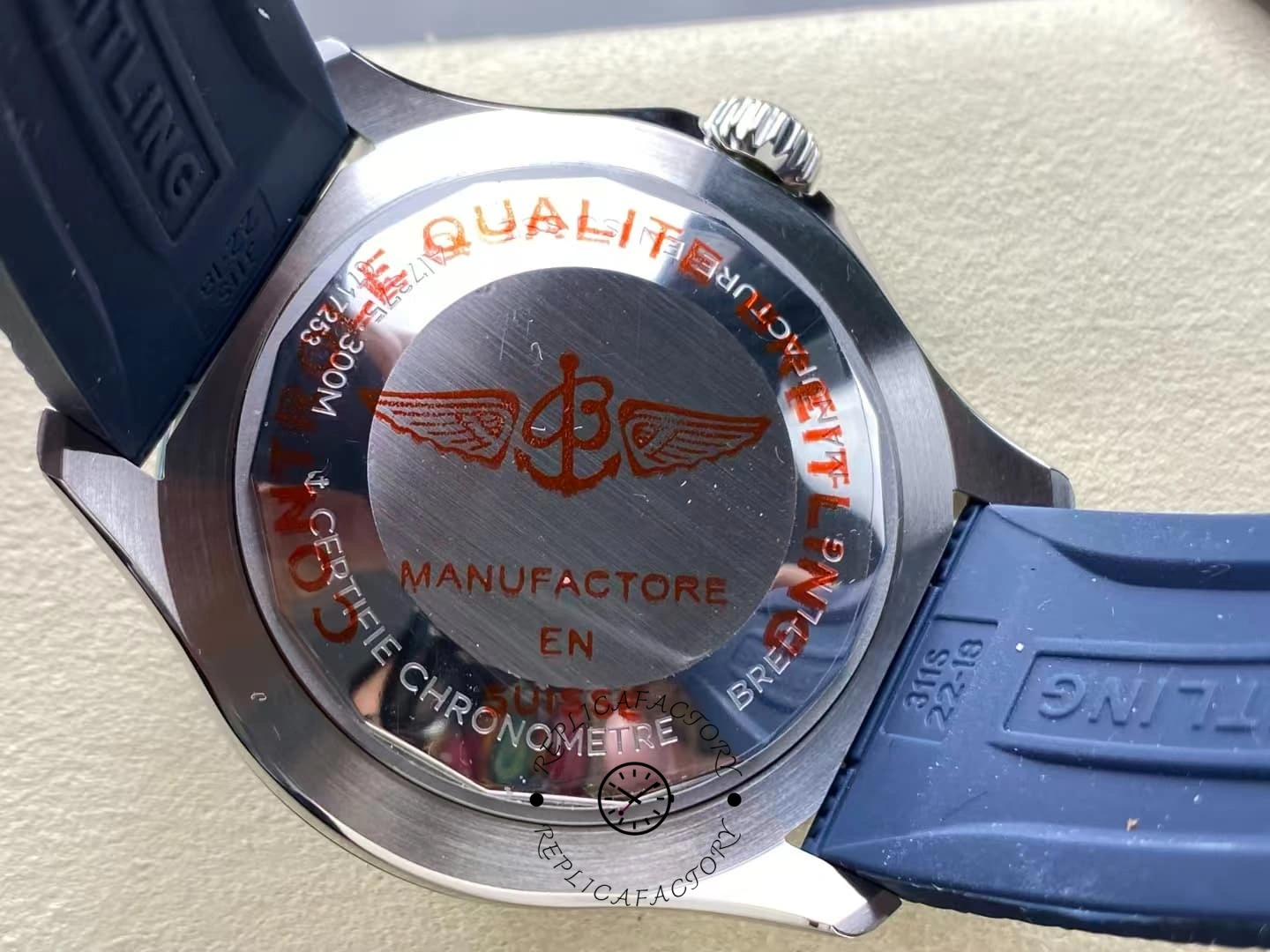 Caseback of Breitling Superocean A17375E71C1S1 with red engraved winged B logo.