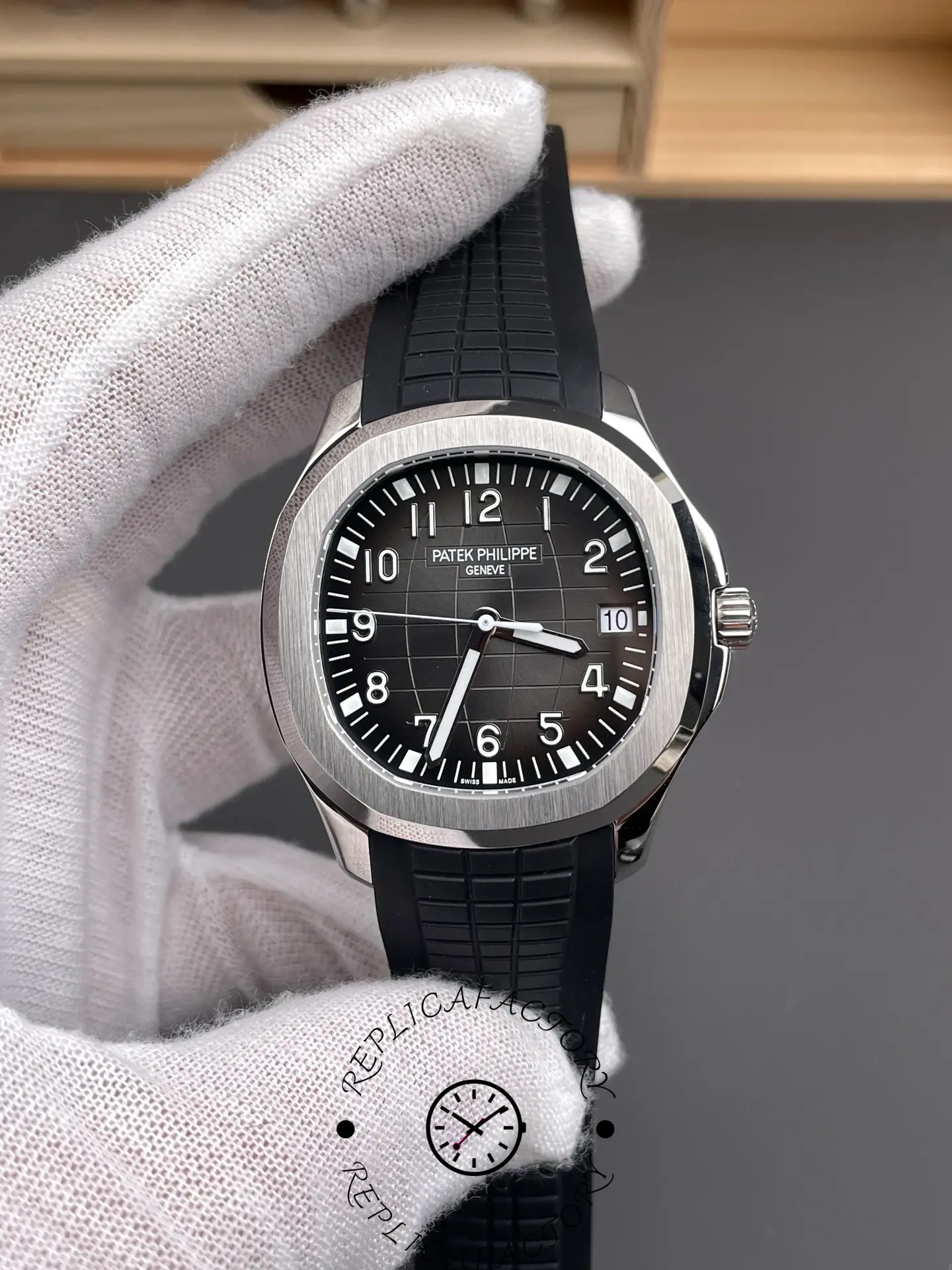 Handheld close-up of the Patek Philippe Aquanaut 5167A-001 showing dial and numerals.