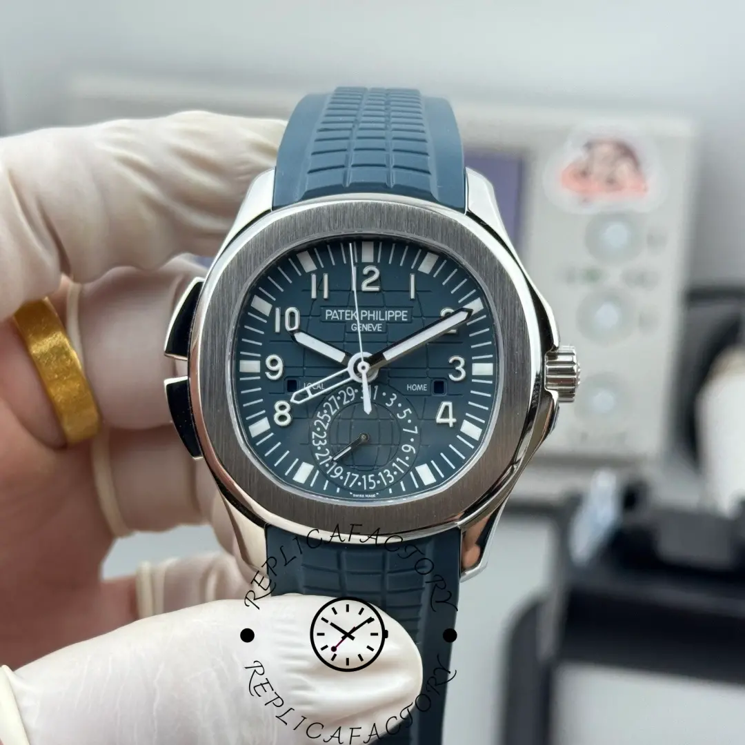 Hand-held front view of the Patek Philippe Aquanaut 5164G-001 with textured blue strap.