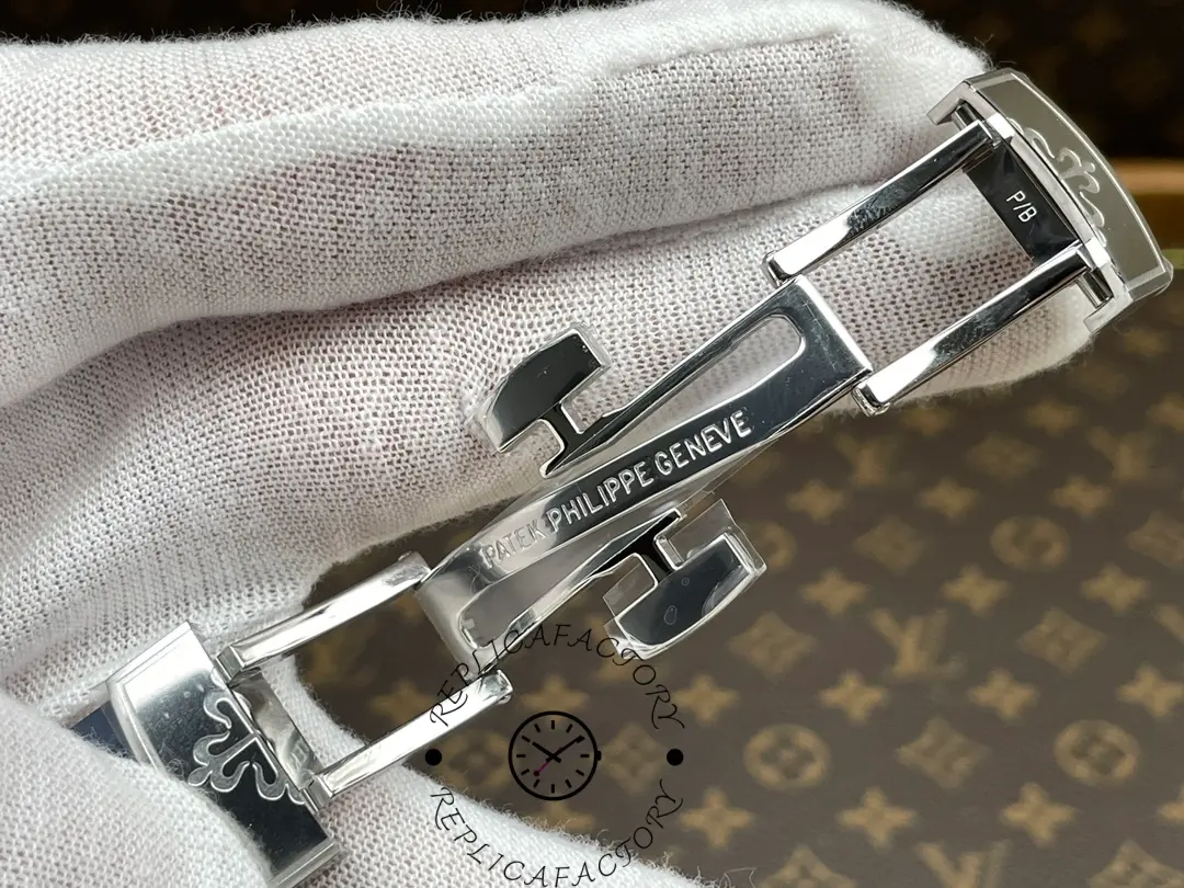 Open clasp mechanism of the Patek Philippe Aquanaut 5168G-001 showing polished folding system.