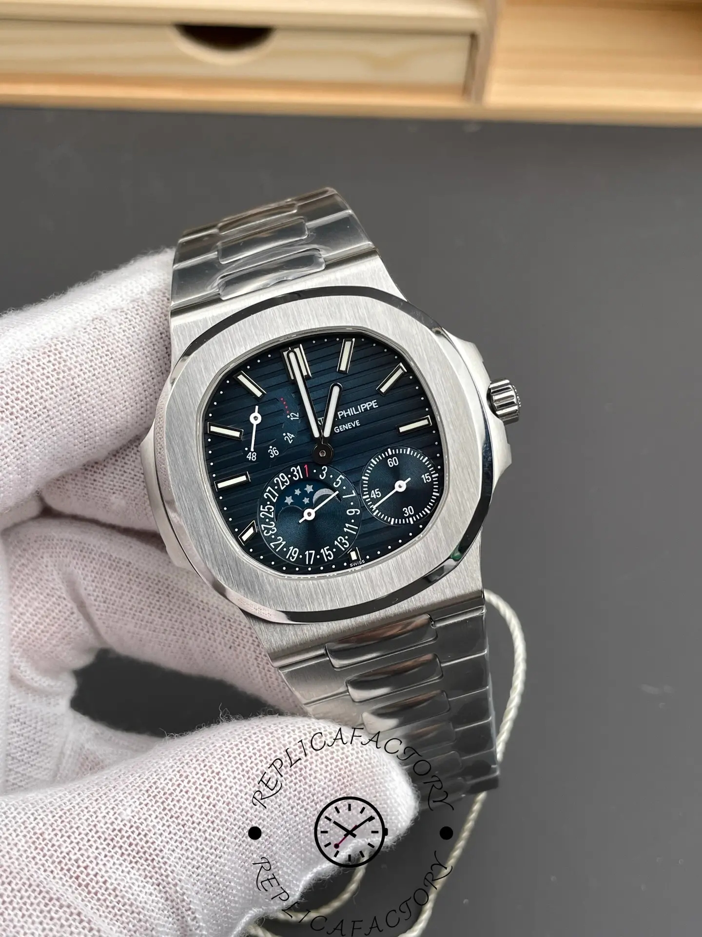Angled view of the Patek Philippe Nautilus 5712/1A-001 highlighting brushed bezel and complications.