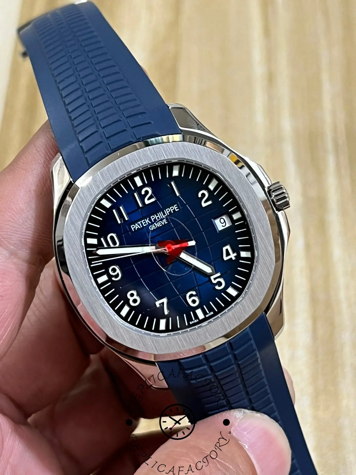 Full front angle of the Patek Philippe Aquanaut 5164G-001 showing luminous numerals and markers.