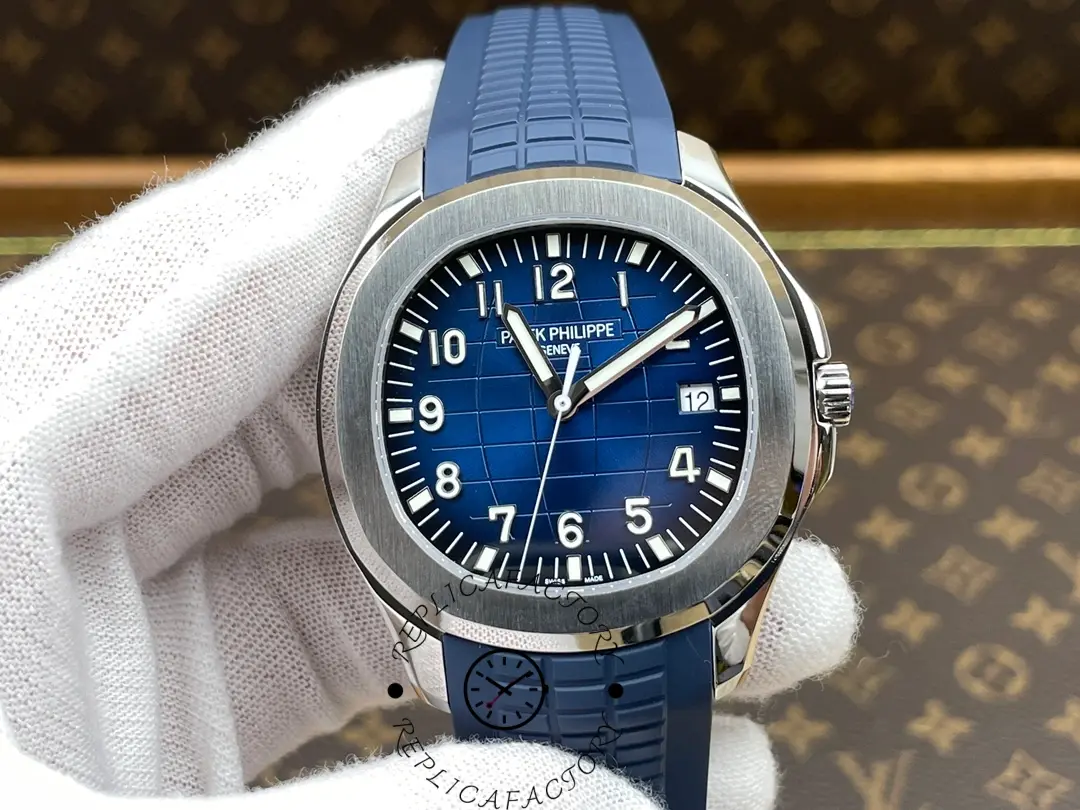 Handheld close-up of the Patek Philippe Aquanaut 5168G-001 blue dial with luminous markers.
