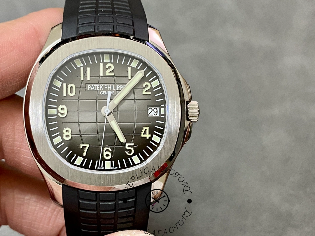 Close-up of the Patek Philippe Aquanaut 5167A-001 dial showing grid texture, luminous numerals, and date window.