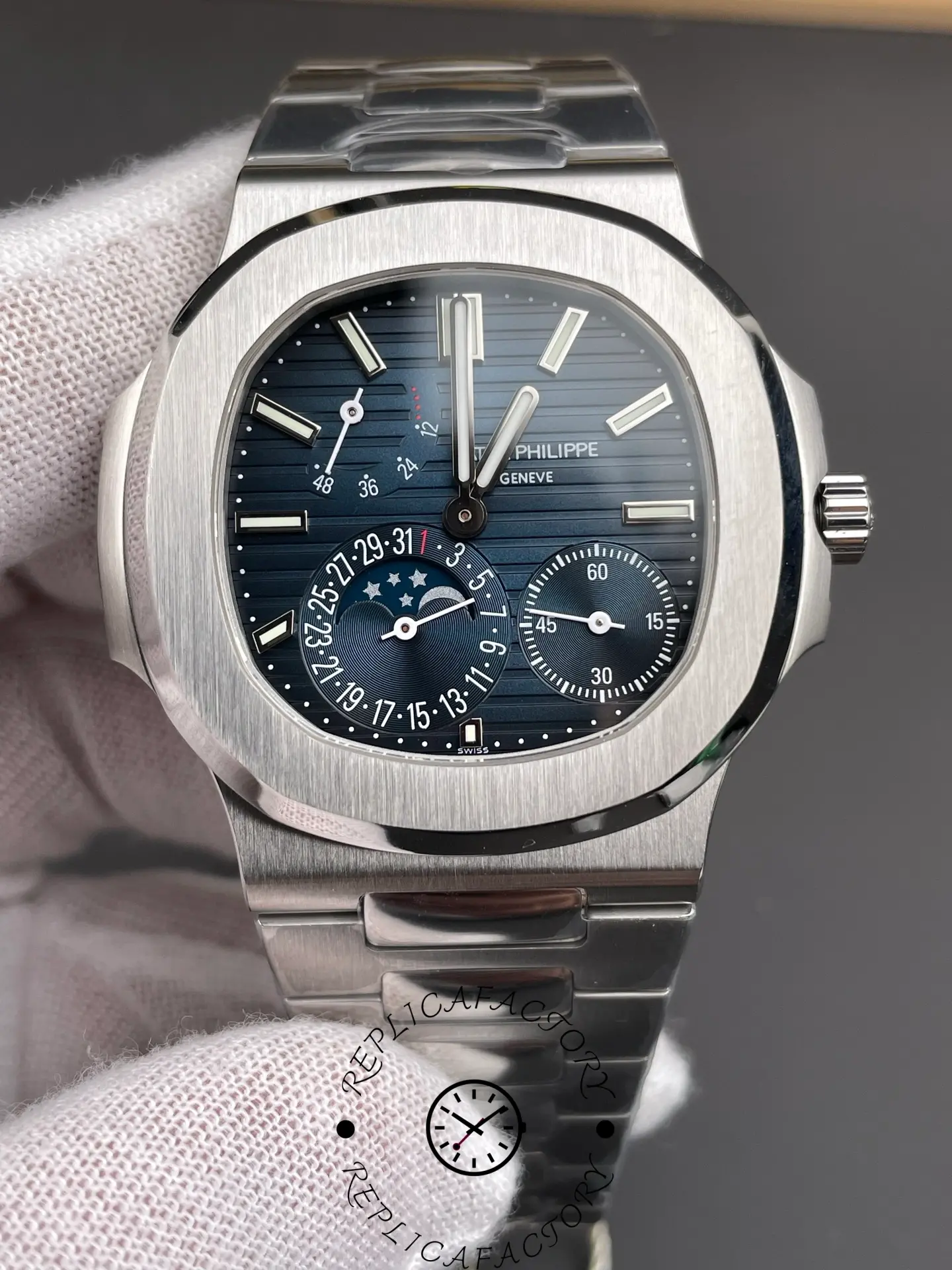 Close-up of the Patek Philippe Nautilus 5712/1A-001 dial with moonphase and date indicators.