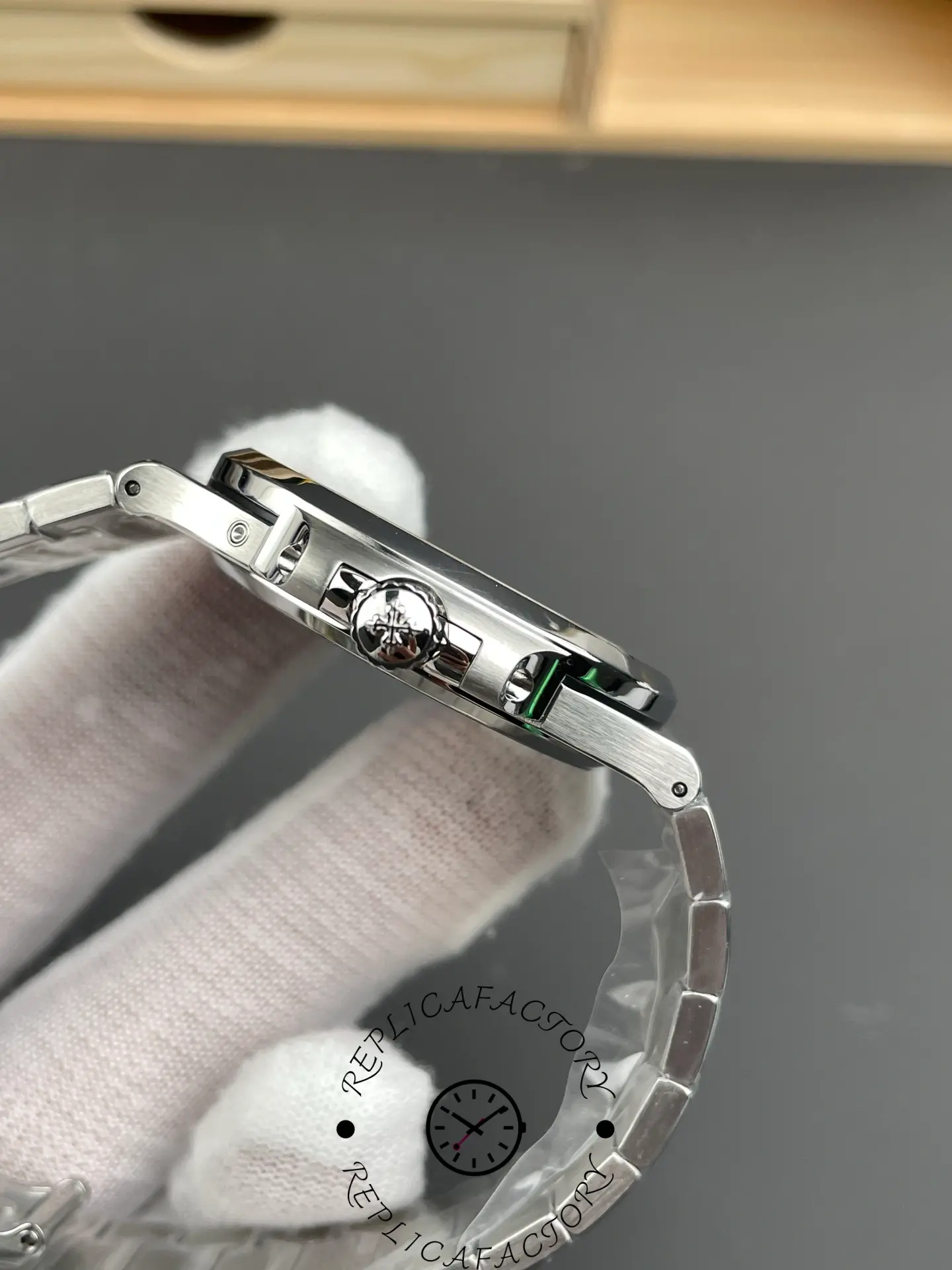 Crown-side view of the Patek Philippe Nautilus 5712/1A-001 with engraved Calatrava cross crown.