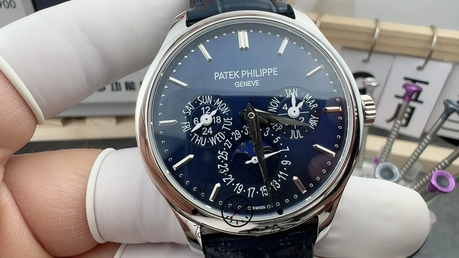 Close-up of the Patek Philippe 5140P-001 dial showing day, month, date and moonphase indicators.
