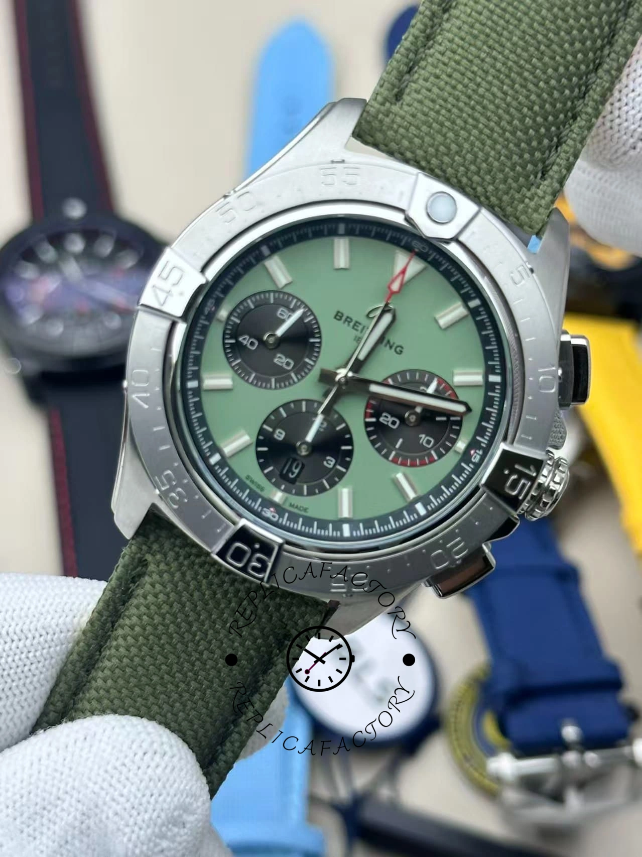 Straight-on view of Breitling Avenger B01 Chronograph 44 AB0147101L1X1 displaying green dial and black subdials.