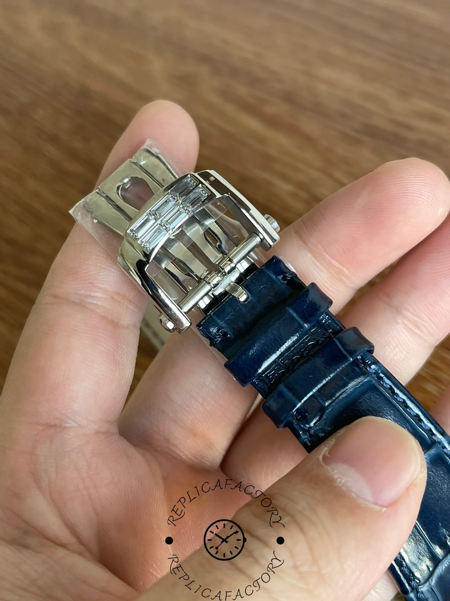 Close-up of Patek Philippe 5724G-001 deployant clasp with baguette diamonds.