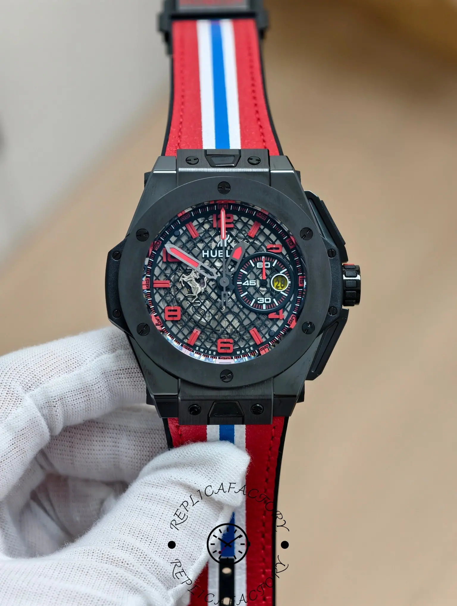 Hand-held shot of Hublot Big Bang 401.CX.1123.VR showing skeleton dial and red racing strap.