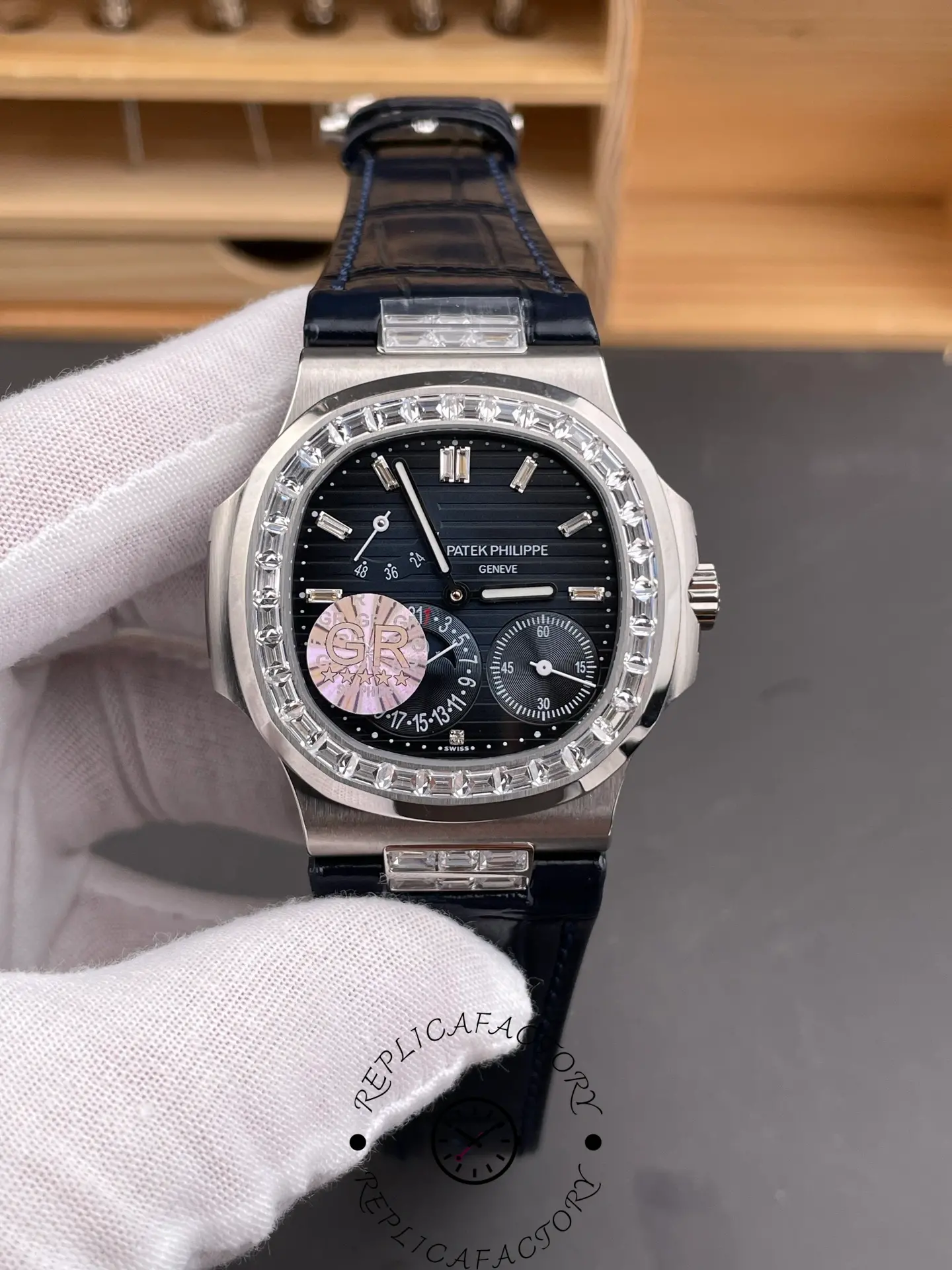 Handheld front view of Patek Philippe 5724G-001 showing diamond bezel and moon phase dial.