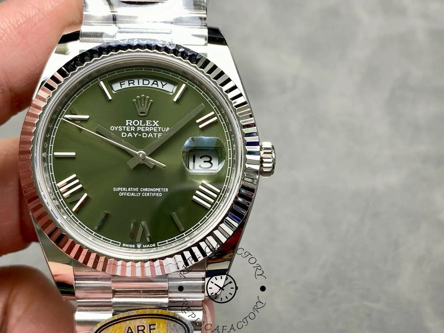 Close-up of Rolex Day-Date 228239 green dial with fluted bezel and date window at 3 o’clock.