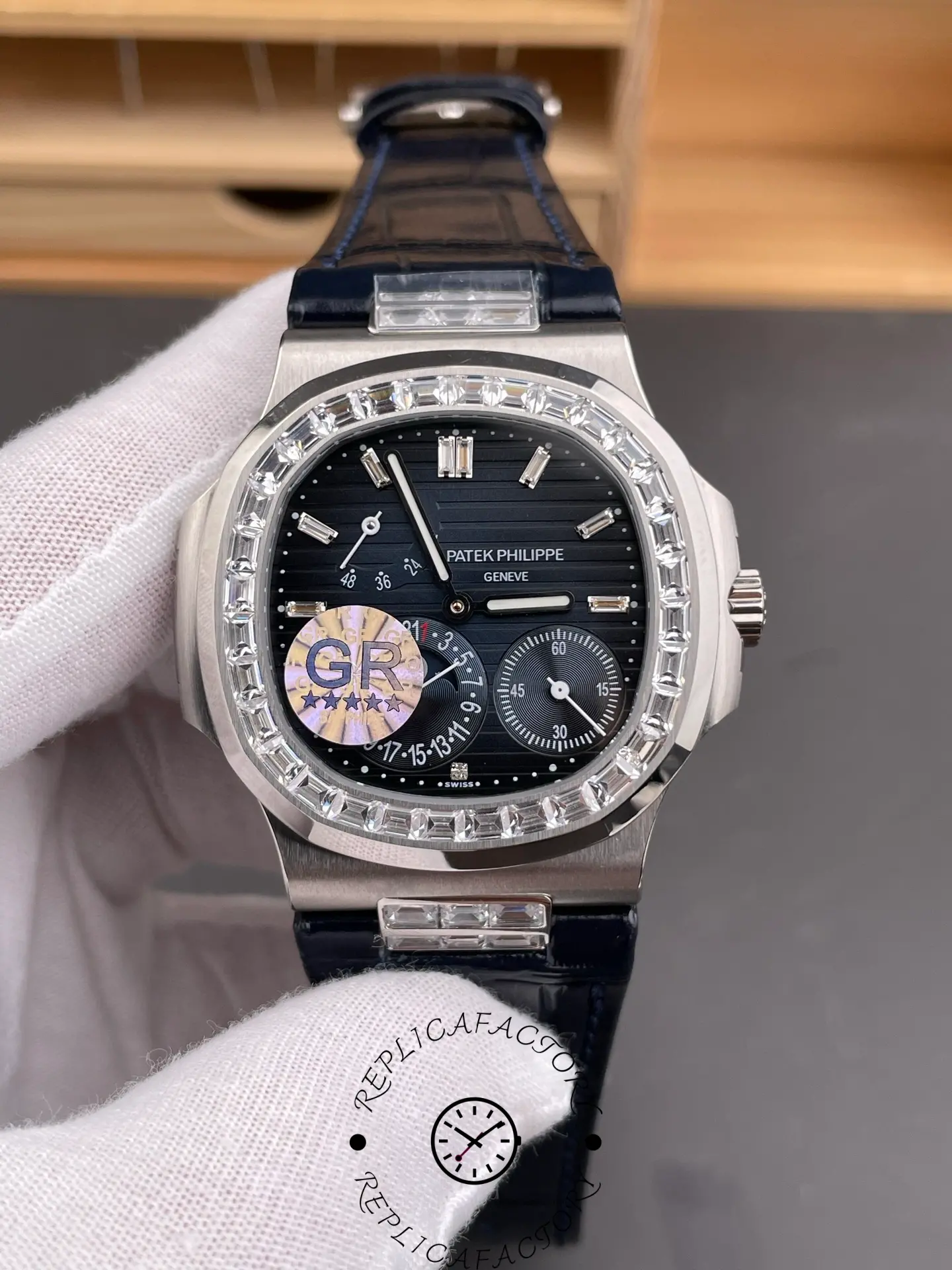 Close-up of Patek Philippe 5724G-001 showing textured dial and diamond-set bezel.