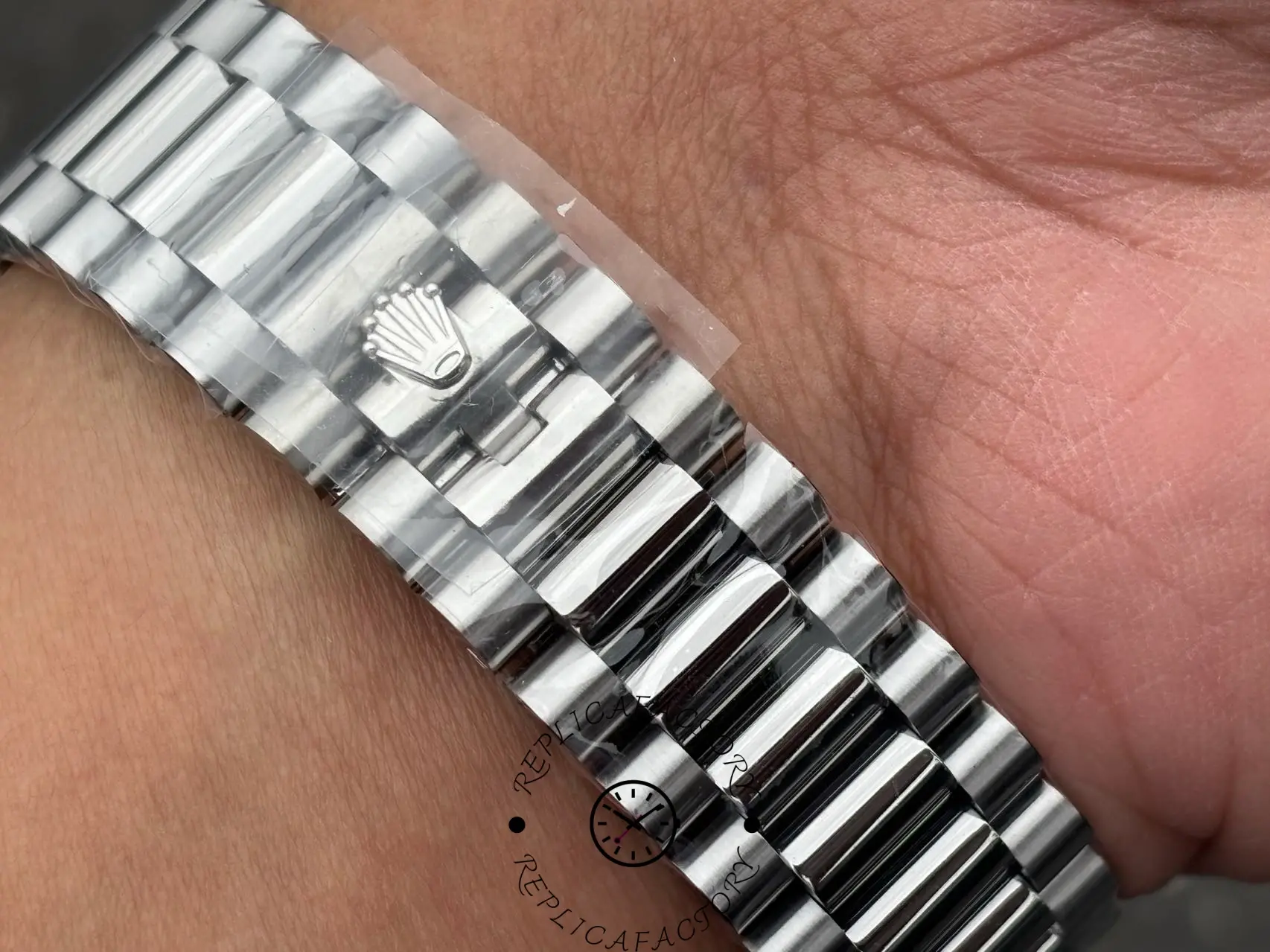 Close-up of Rolex Day-Date 228239 President bracelet clasp with engraved Rolex crown.