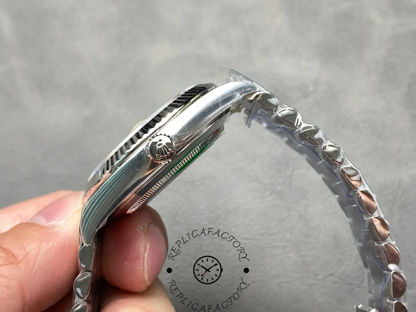 Side profile of Rolex Day-Date 228239 highlighting fluted bezel and crown with Rolex logo.