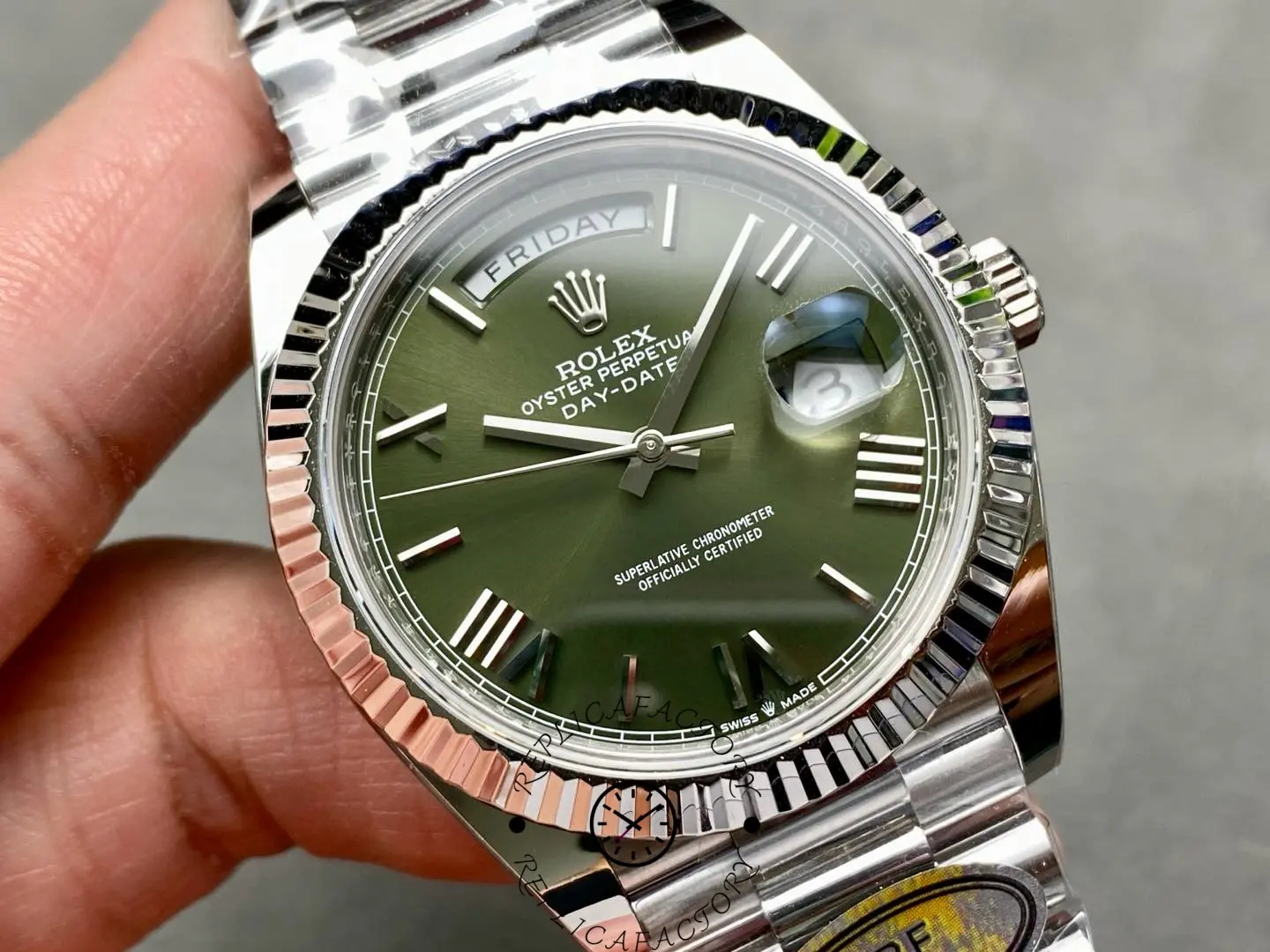 Angled close-up of Rolex Day-Date 228239 showing green sunburst dial and polished bezel.