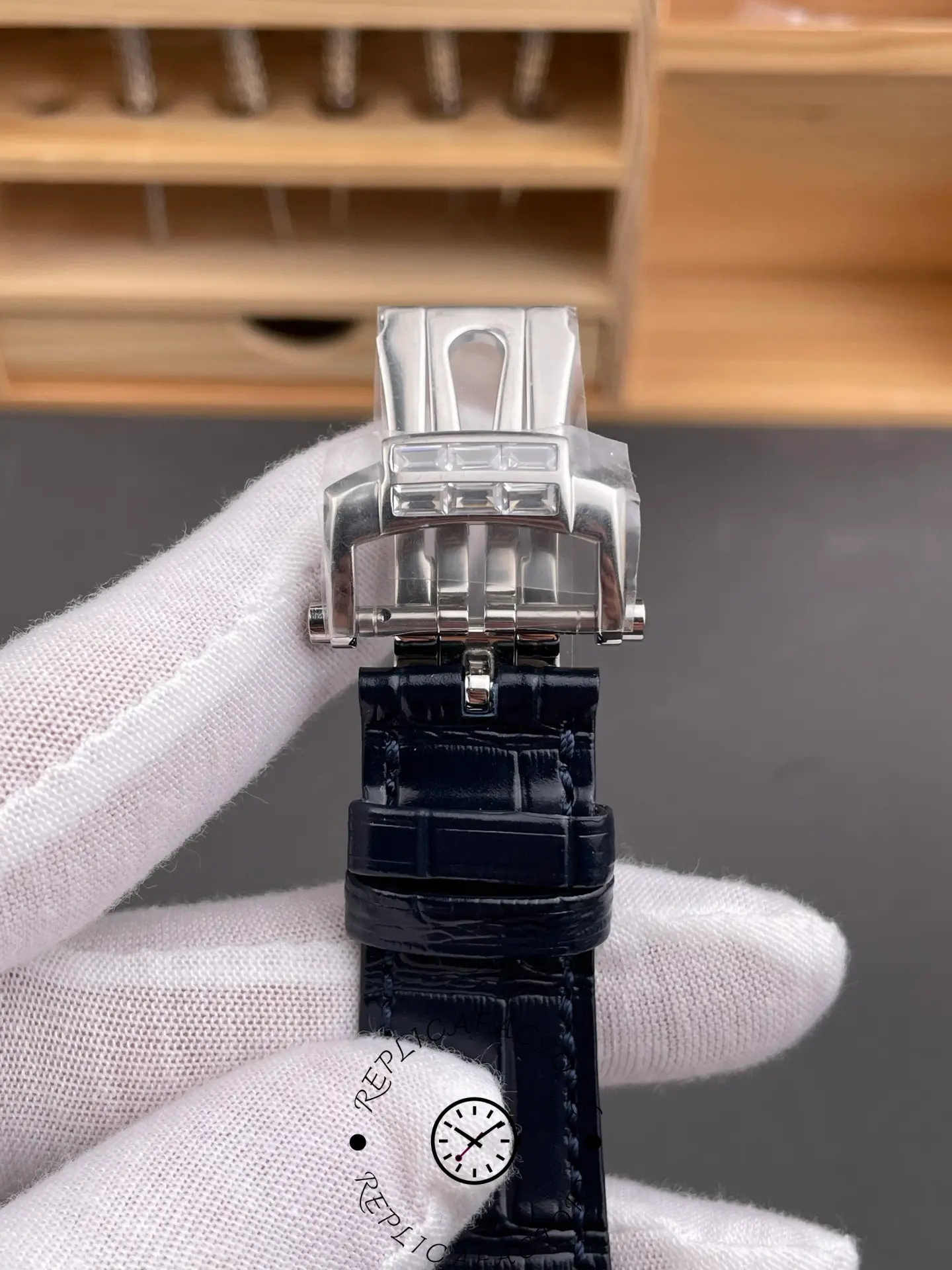 Clasp view of Patek Philippe 5724G-001 showing diamond-set clasp and polished finish.