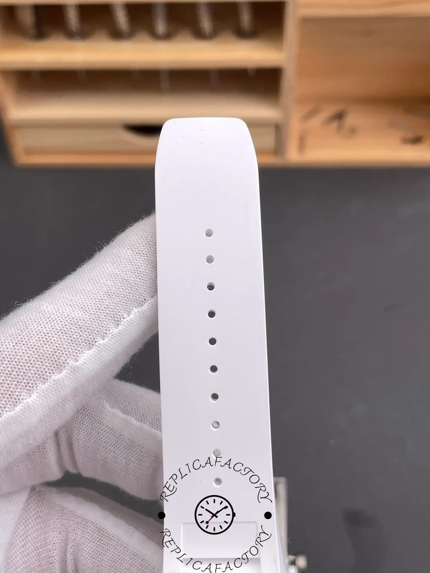 Close-up of white rubber strap of Richard Mille RM055 RMUL2 with adjustment holes.