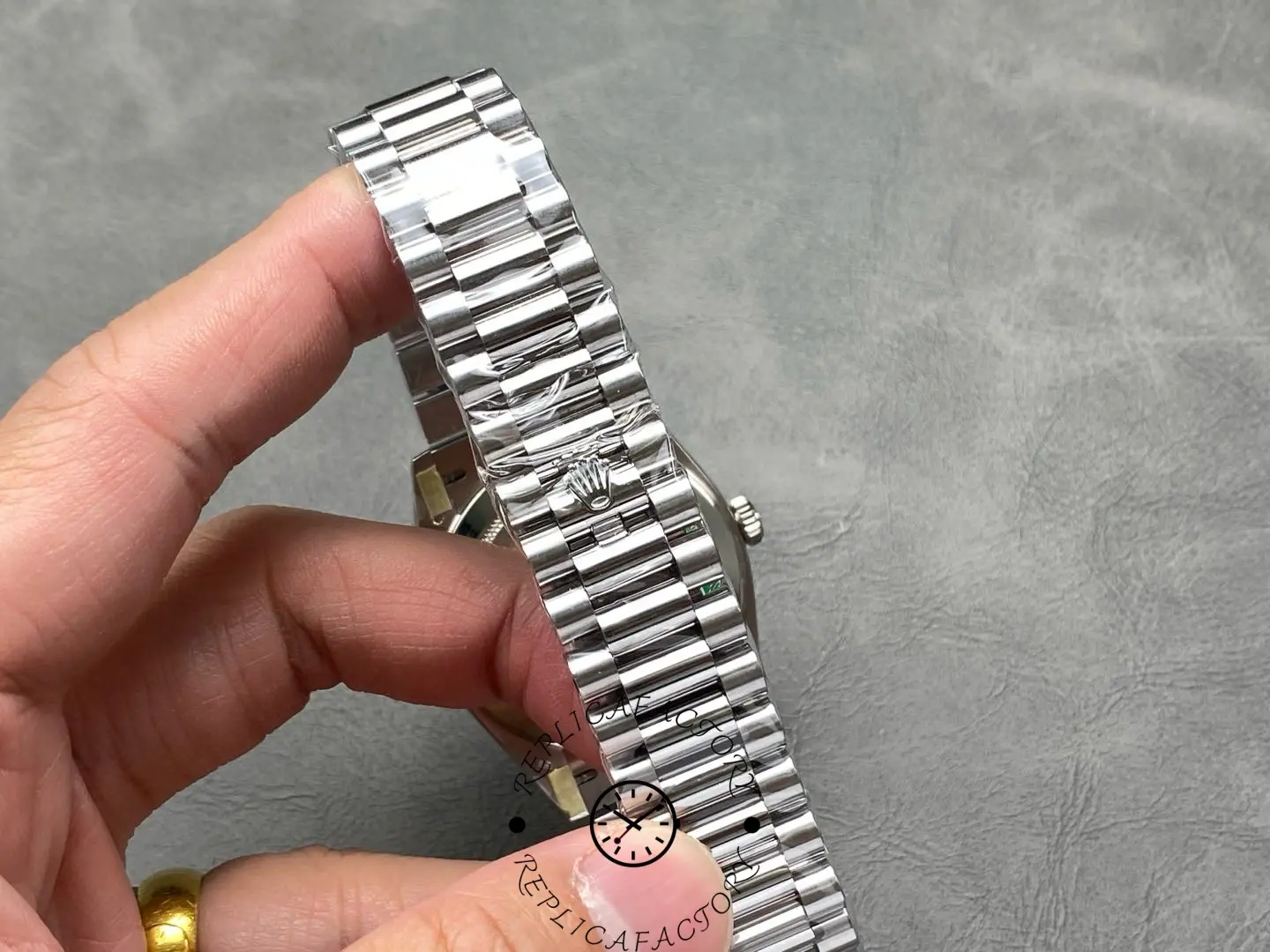 Close-up of Rolex Day-Date 228239 President bracelet with polished center links.