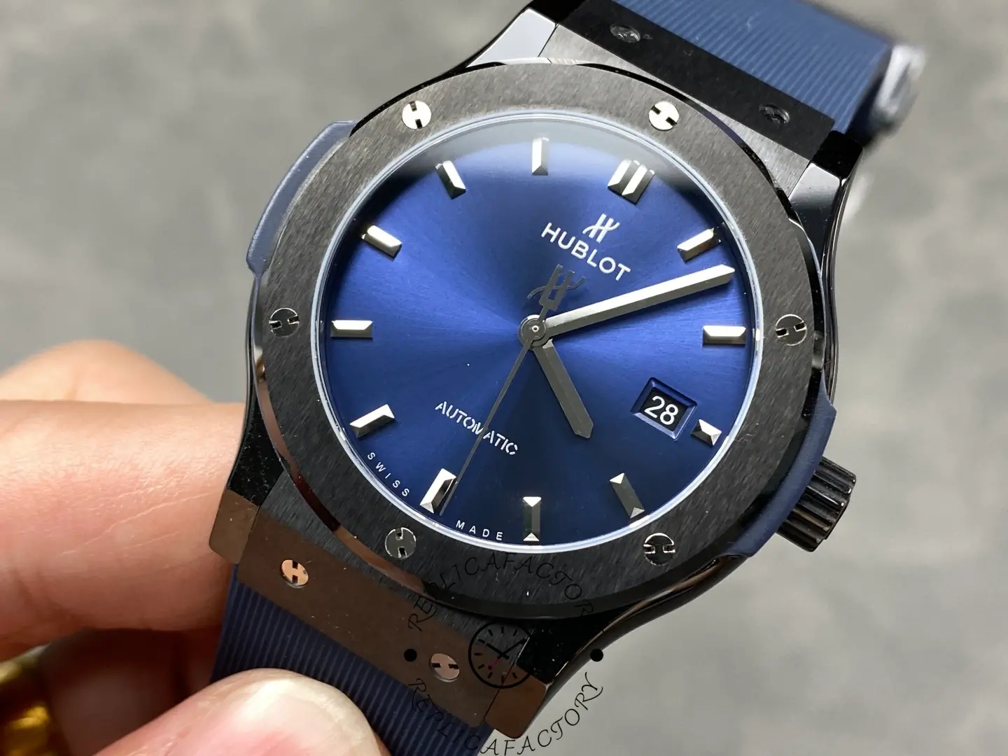 Hublot Classic Fusion 542.CM.7170.RX showing blue dial, baton markers, and date display.