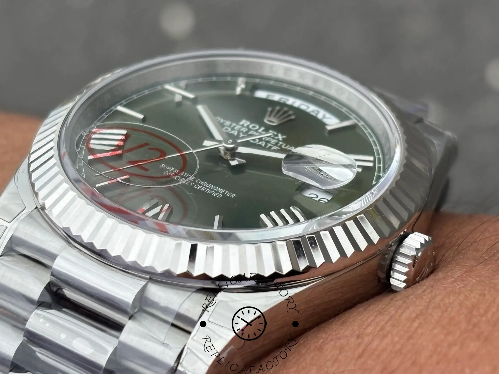 Side view of Rolex Day-Date 228239 highlighting the fluted bezel and crown with Rolex logo.